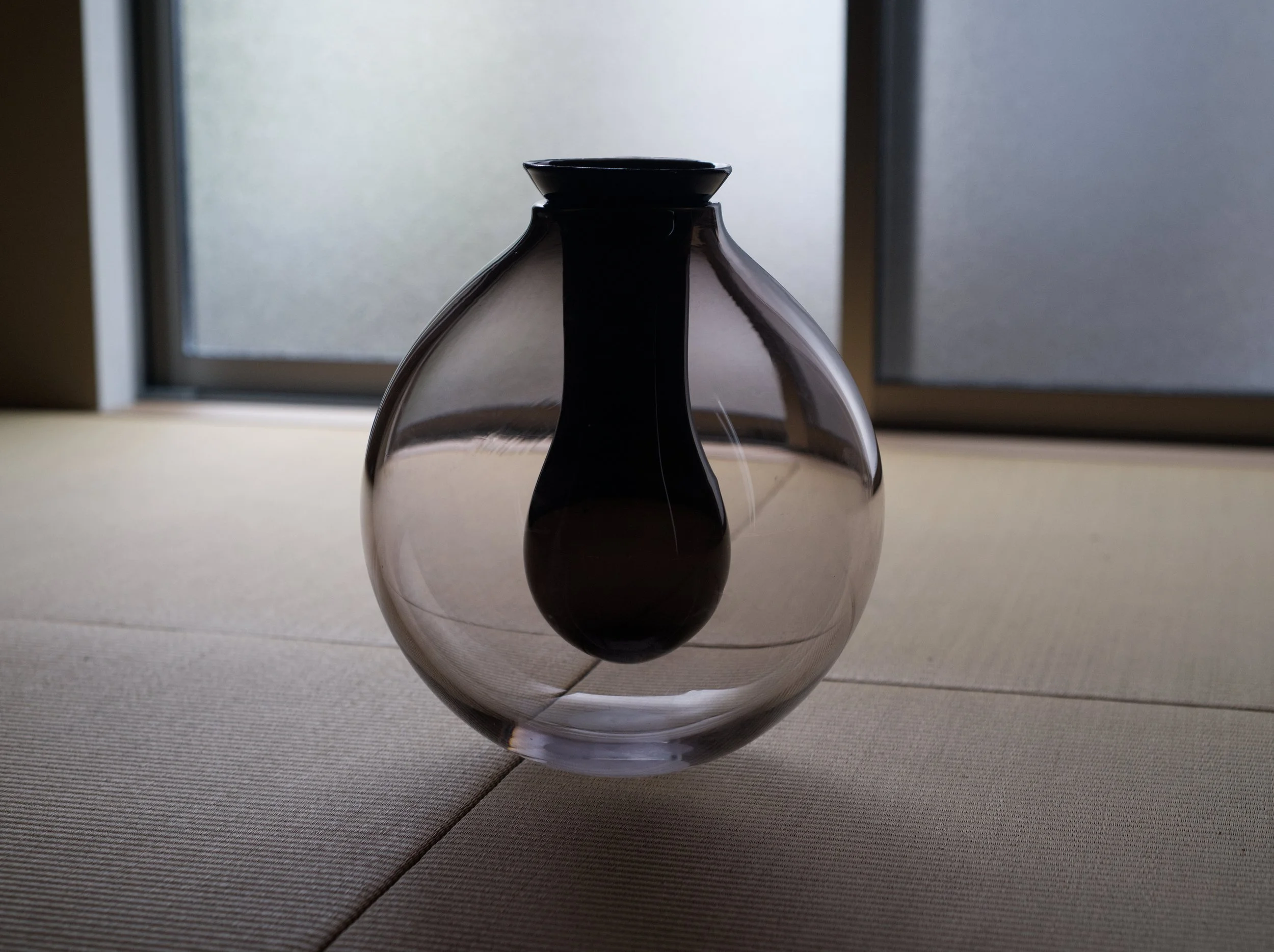   Uchi,  blown glass.  This work takes on the seemingly impossible task of nesting one form inside of another, without fusing them together permanently, but disallowing their separation. They are not bound together strictly or entirely, but have limi
