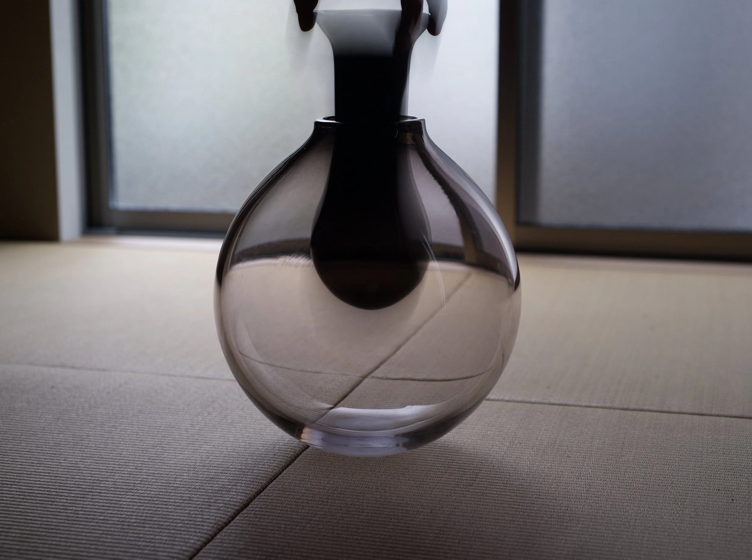   Uchi,  blown glass.  This work takes on the seemingly impossible task of nesting one form inside of another, without fusing them together permanently, but disallowing their separation. They are not bound together strictly or entirely, but have limi