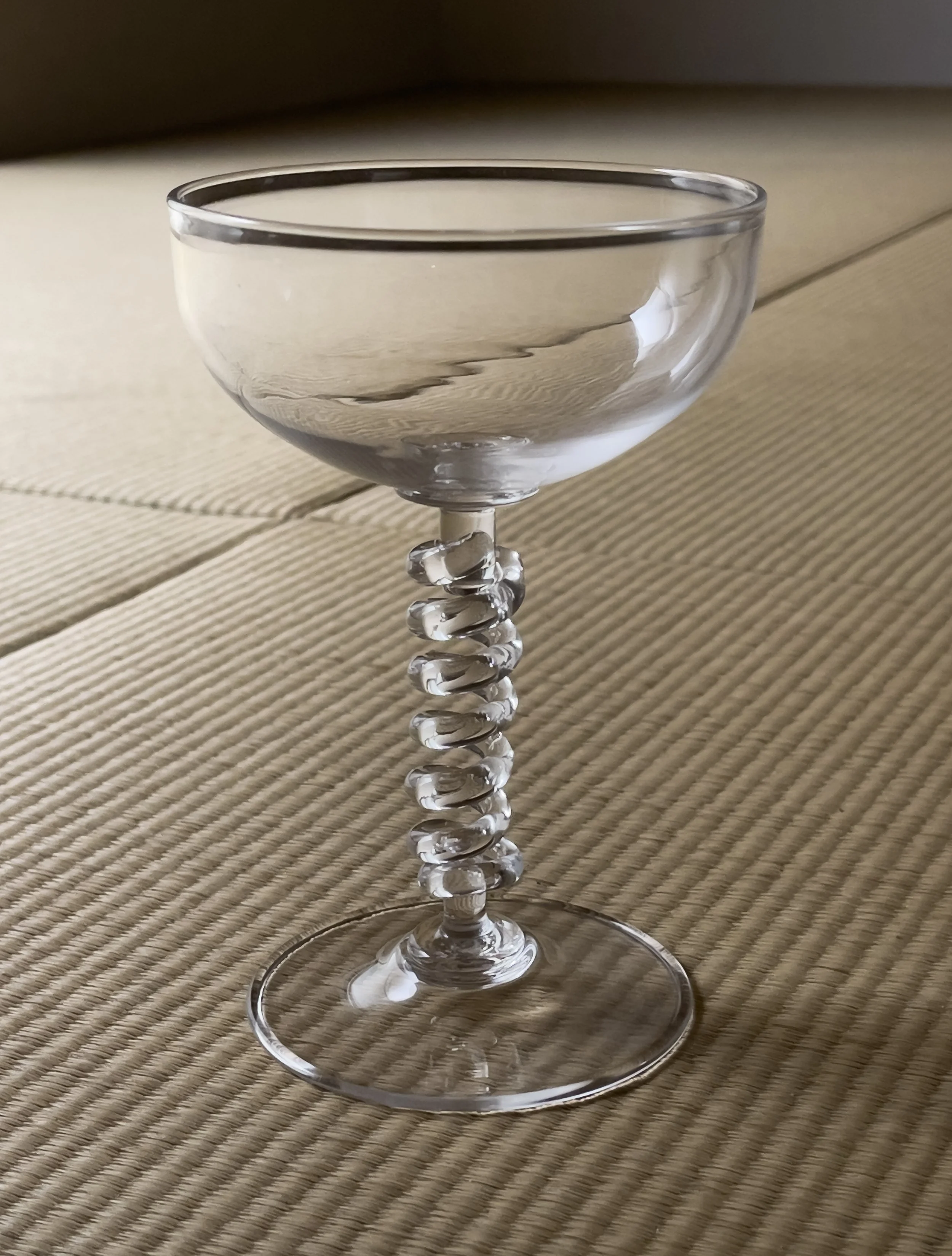   Coil Cup , blown glass  The flexibility of the stem allows this vessel to vibrate when struck at the bell of the cup, upending expectations about glass’s material qualities, e.g. rigidity and fragility. 