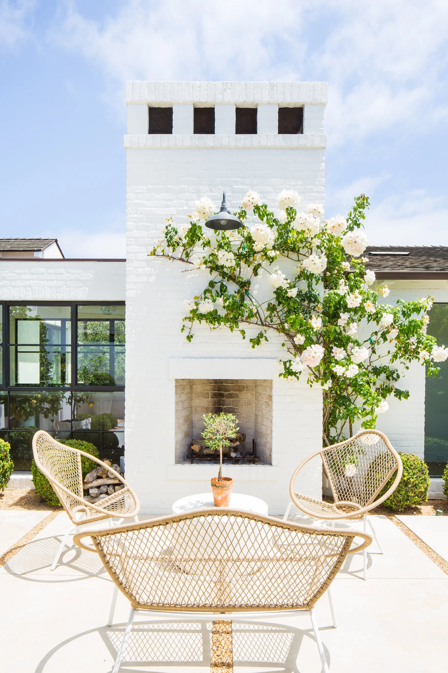 Modern Farmhouse Back Porch with Fireplace - Kelly Nutt Design .jpg