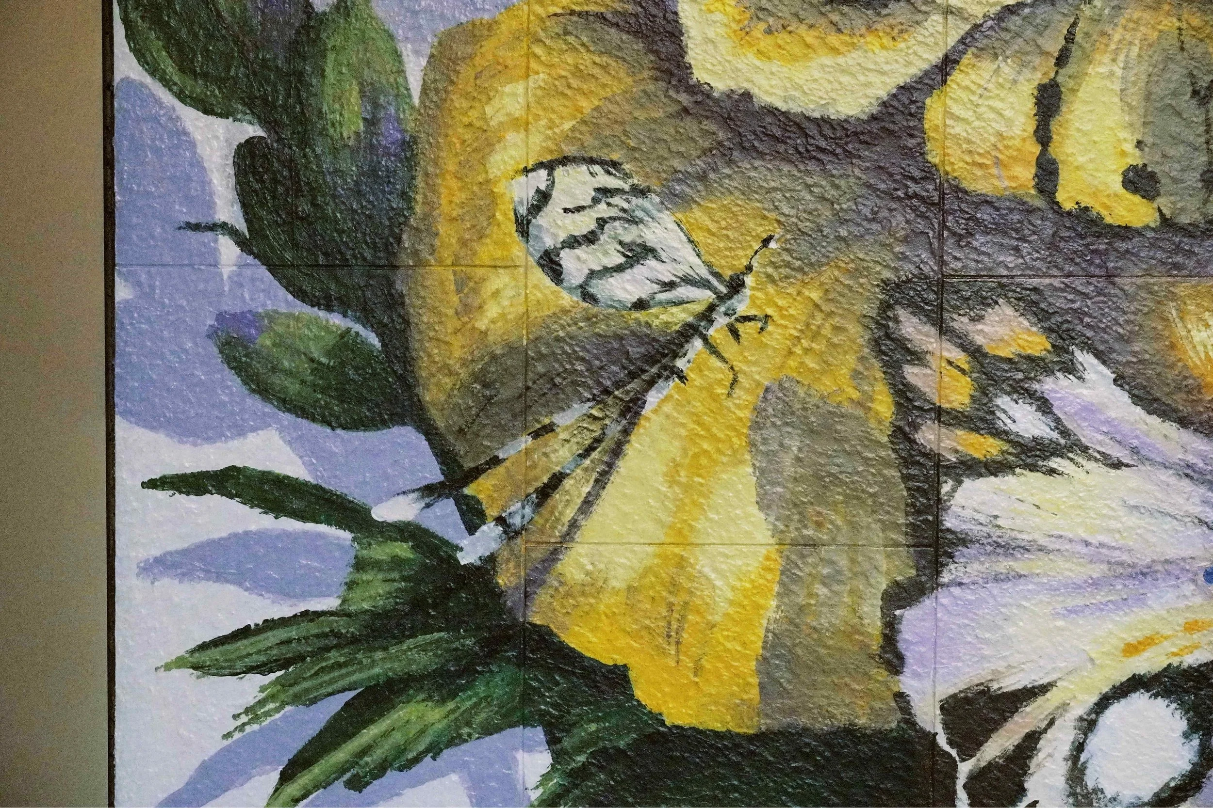 A mural created and painted by artist Neil Wang features a close-up of a black and white patterned dragonfly resting on a flower-like, whimsical yellow butterfly in Novoland Hong Kong by Sun Hung Kai Properties.