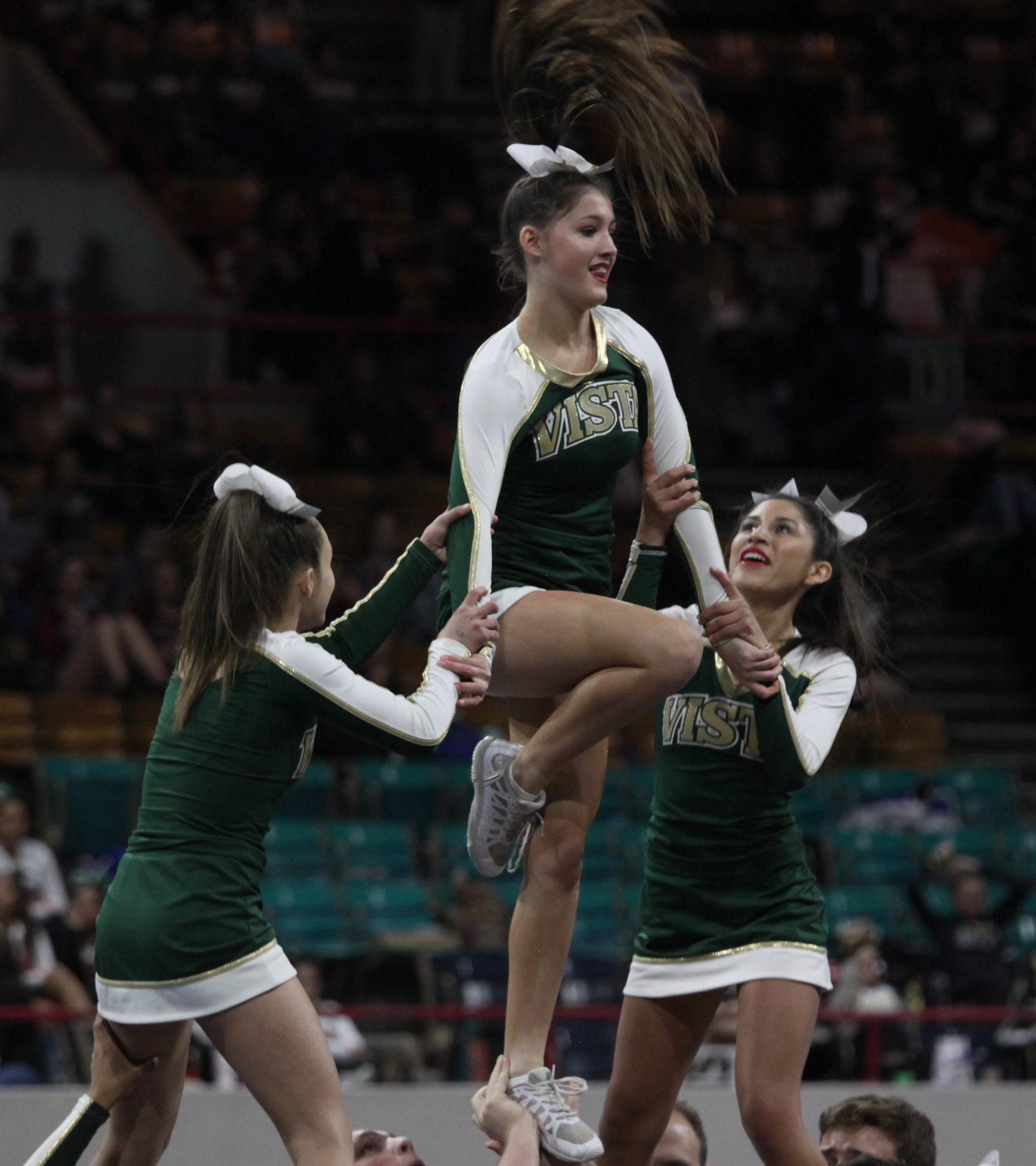Sophomore Taylor Black is flipped during a routine at the Cheer State Competition. 