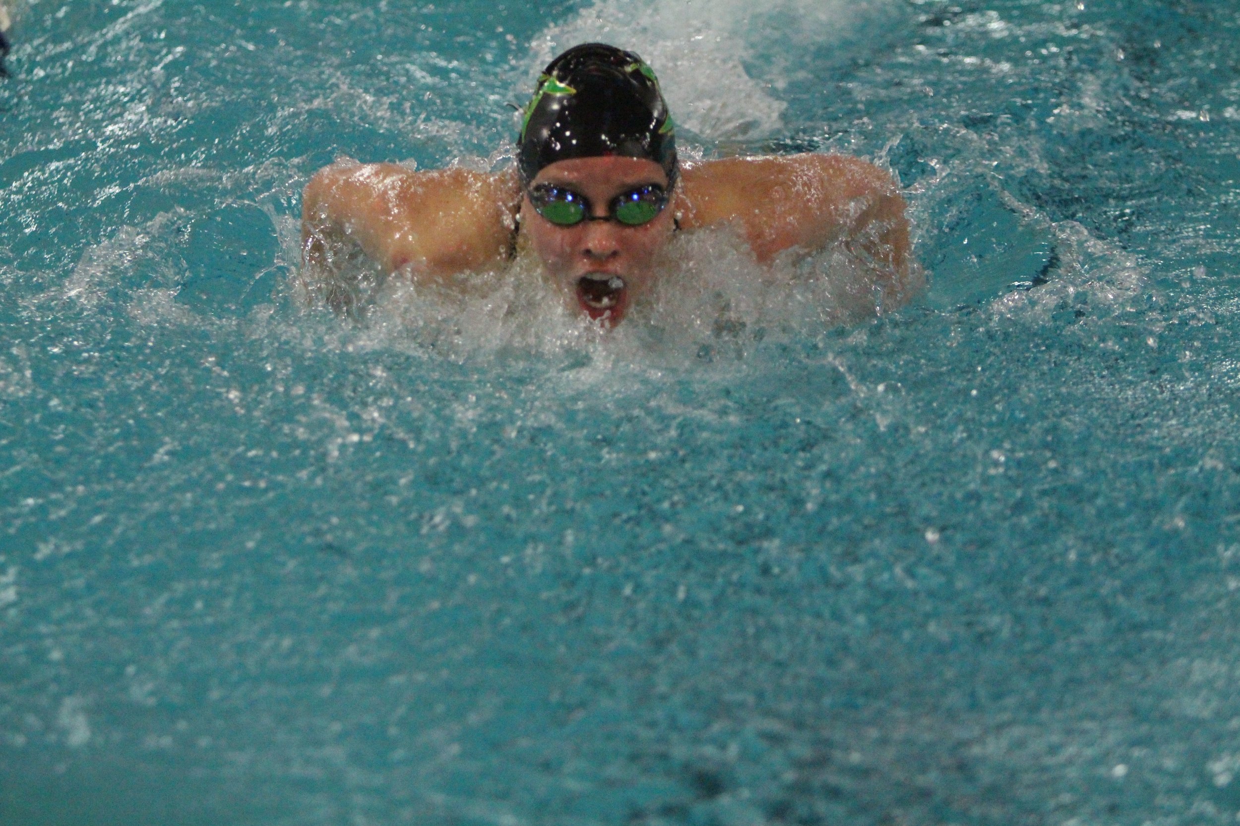 Junior Teagan Haberkorn swims the butterfly during a home meet. 