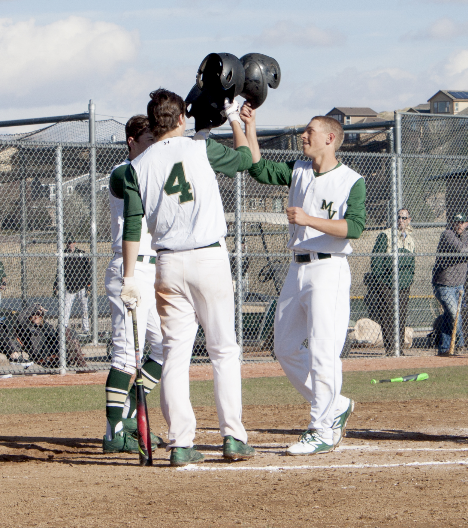 Senior Cole Blachford is congratulated by his teammates after hitting a home run. 