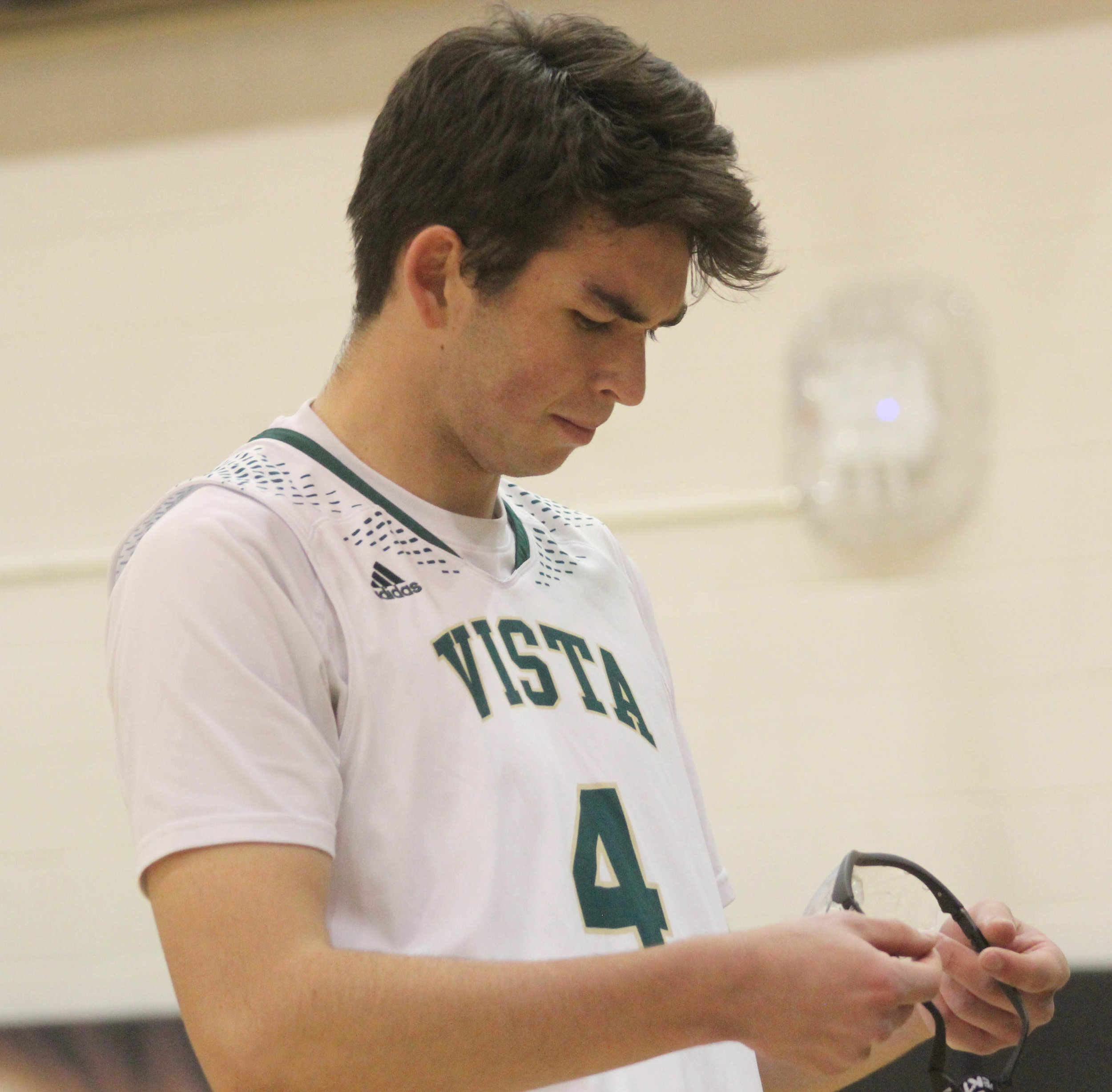 Senior Garrett Sweeney looks at glasses thrown to him from the crowd when his name was announced at the first home game of the season. 
