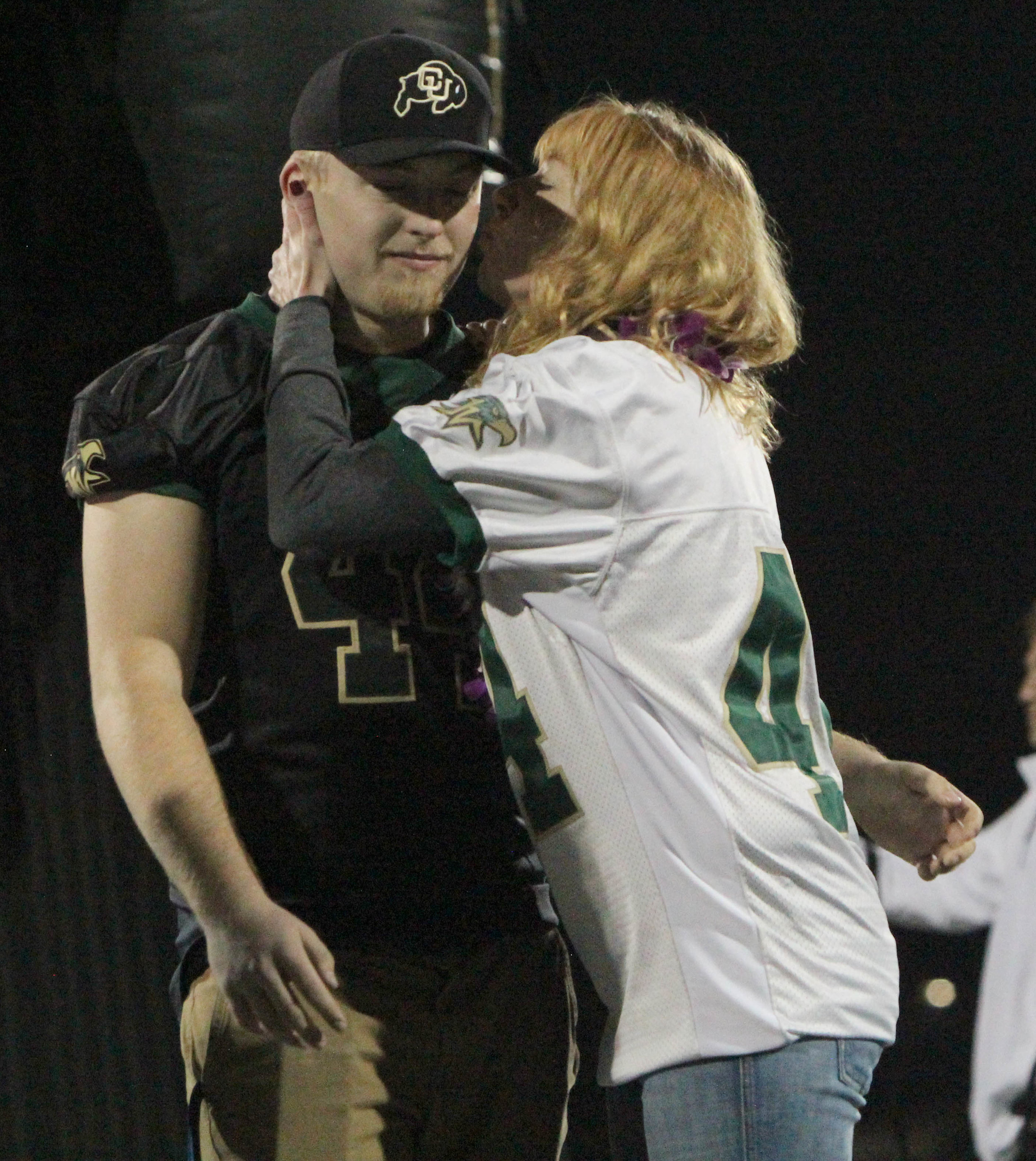 Senior Trevor Jasper receives a comforting kiss from his mom before his last high school football game. 