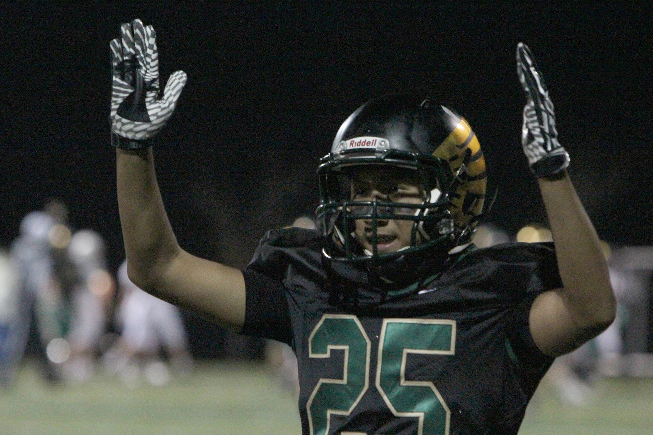 Junior Vinny Mac celebrates the extra point in the football game against Poudre. 