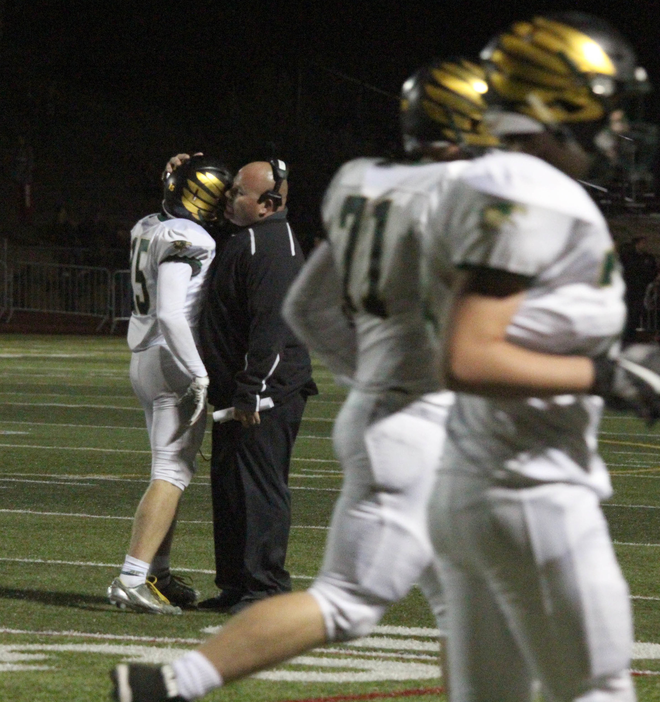 Senior Brady Stevens is hugged by his coach after kicking his first field goal ever. 