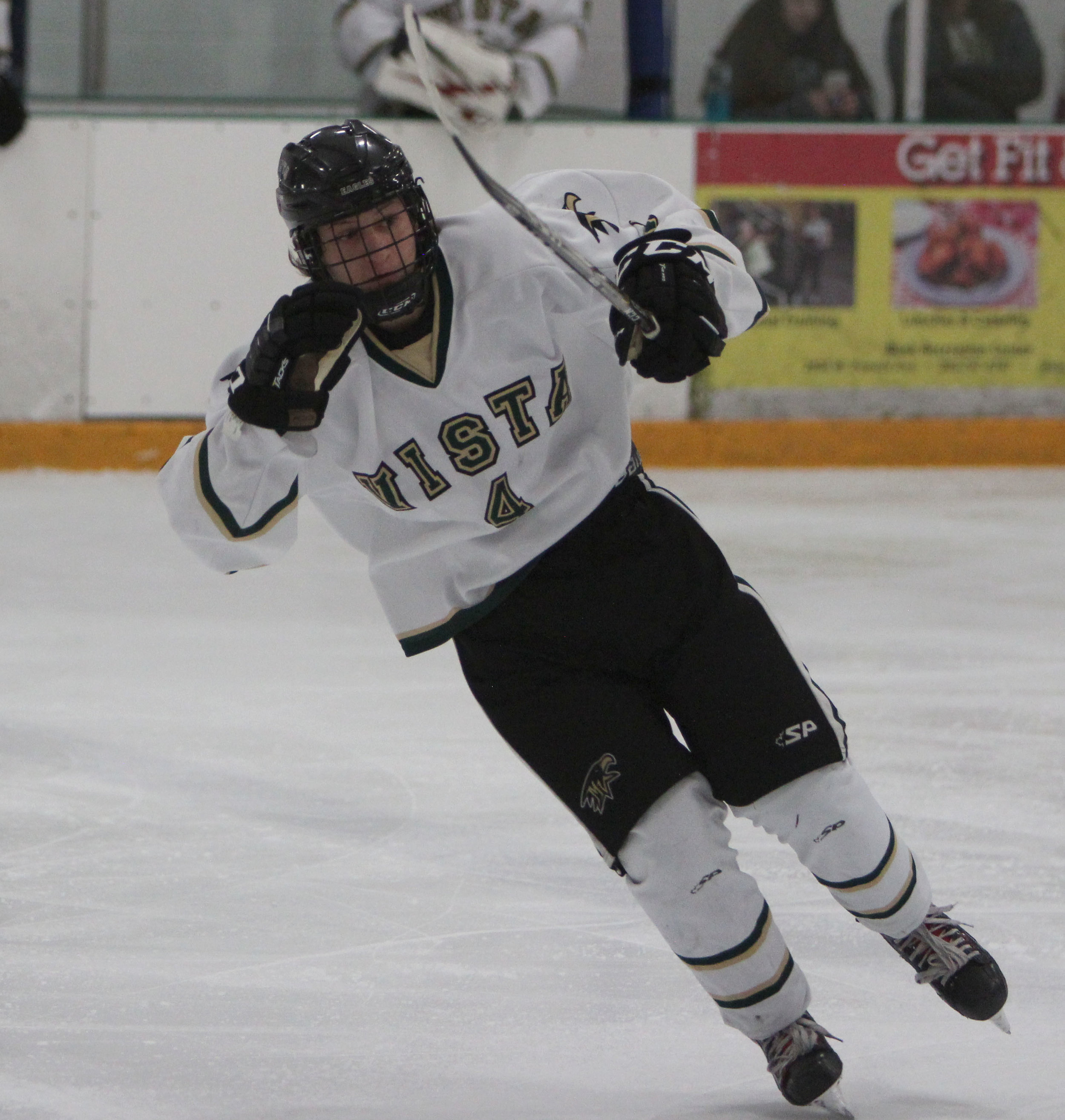 ThunderRidge's Sam Lepper skates over to stop a Denver East opponent in a home game. 