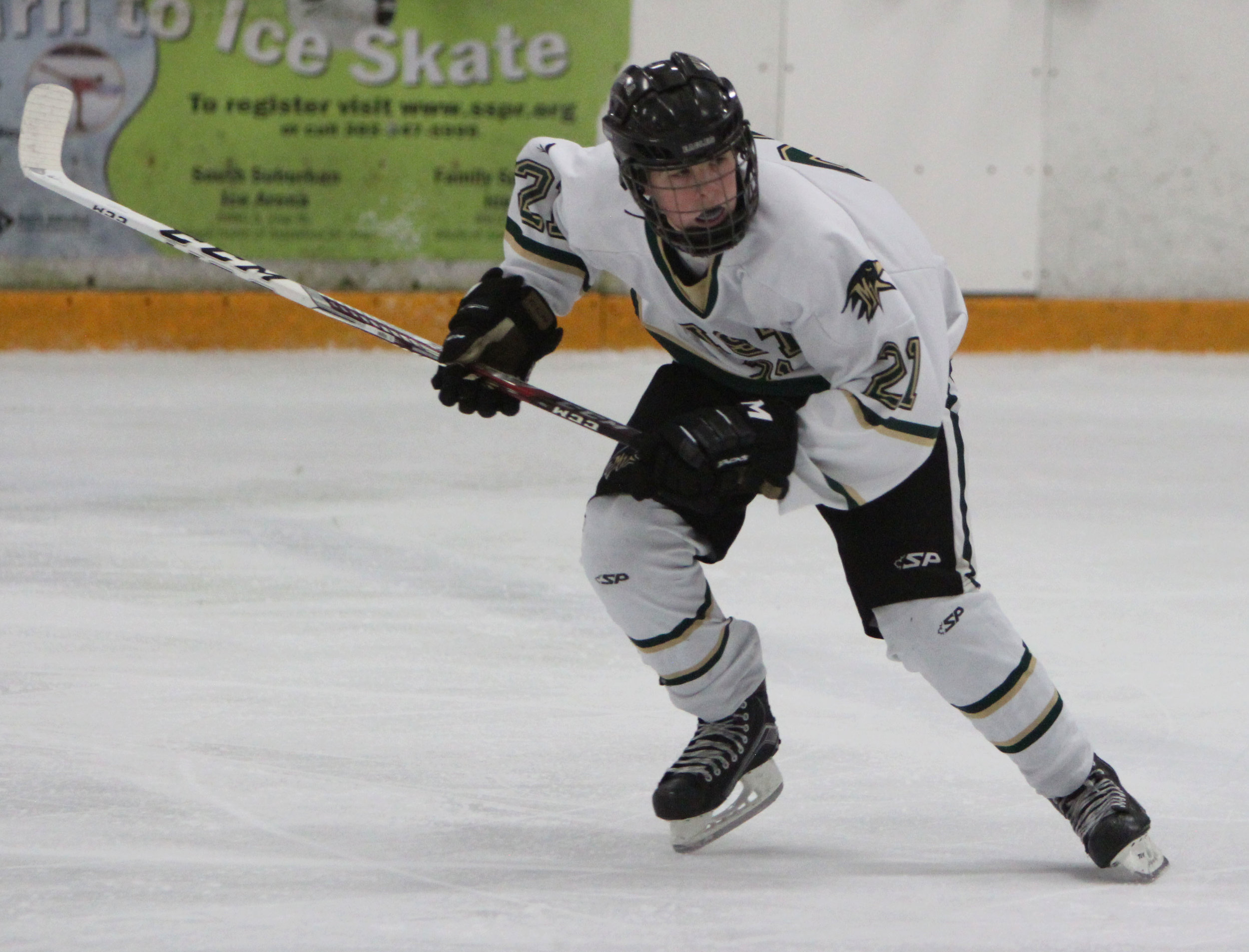 Junior Caden Hunter skates back towards the goal to help on defense in a home game against Denver East. 