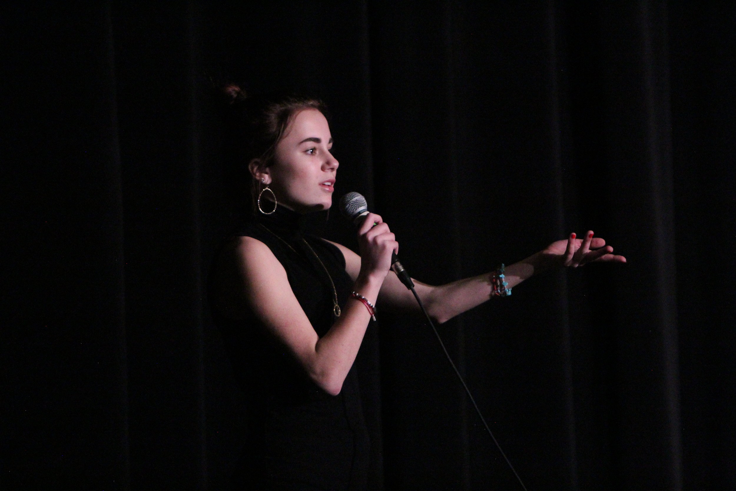  Sophomore Emma Holt preforms her original poem at the annual slam poetry competition put on by the English department.&nbsp; 