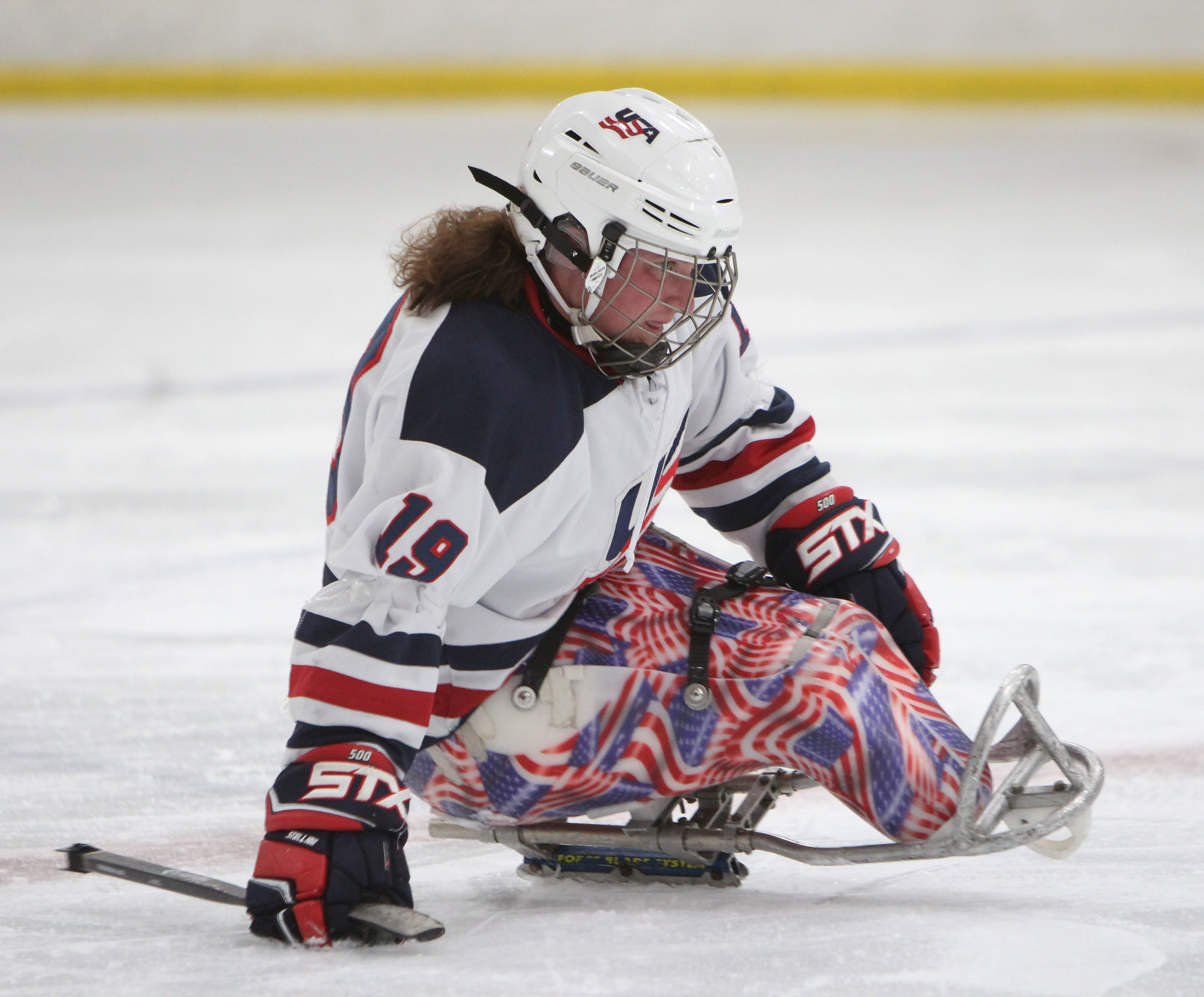 Kelli Anne Stallkamp, a USA Disabled Sled Hockey defender, skates towards the puck in a game against the Colorado Avalanche. 