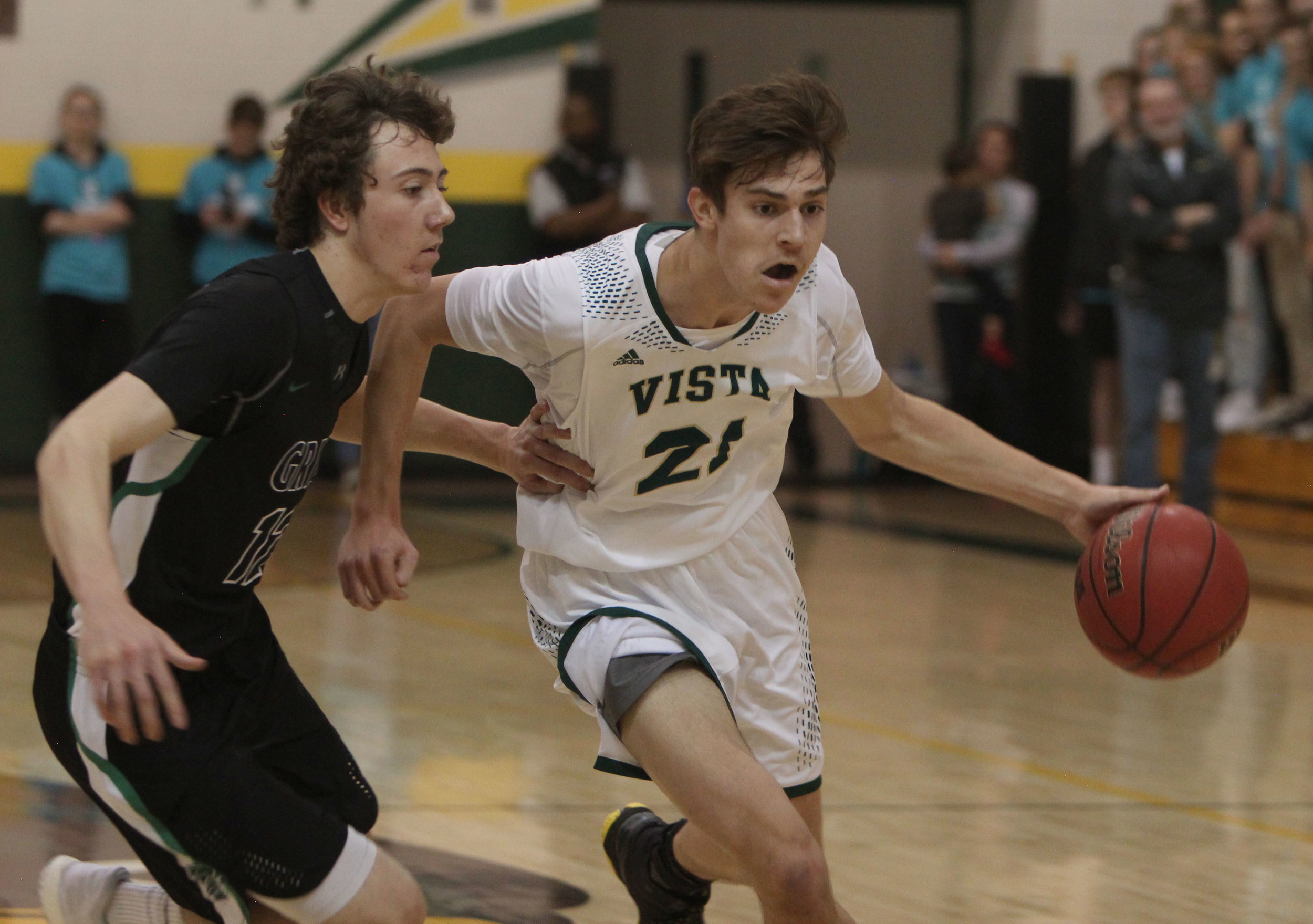 Senior Connor Staib dribbles around his opponent in the rivalry game against ThunderRidge High School. 