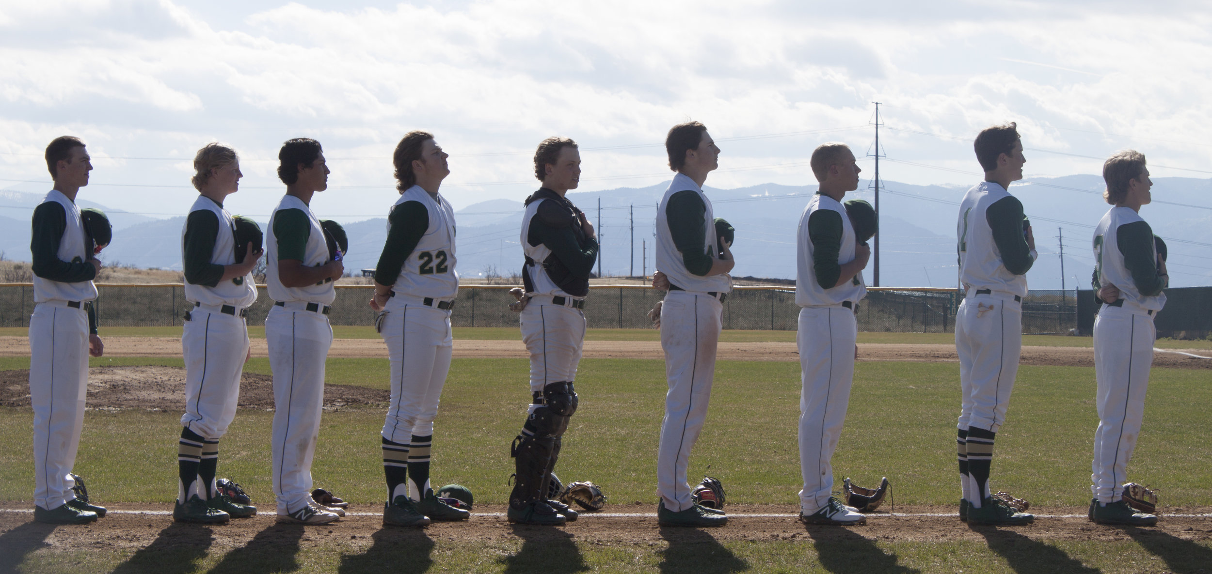 Vista varsity baseball players line up for the National Anthem before the biggest game of the season. 