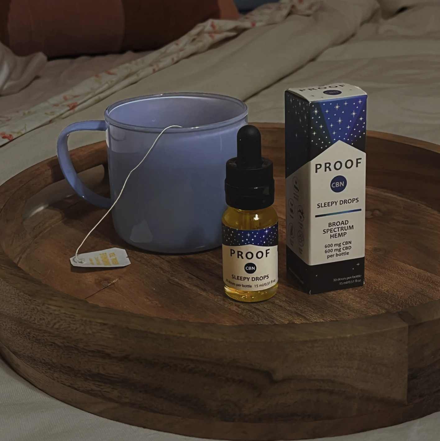 Proof Remedy CBD Sleepy Drops on a tray with a tea cup 
