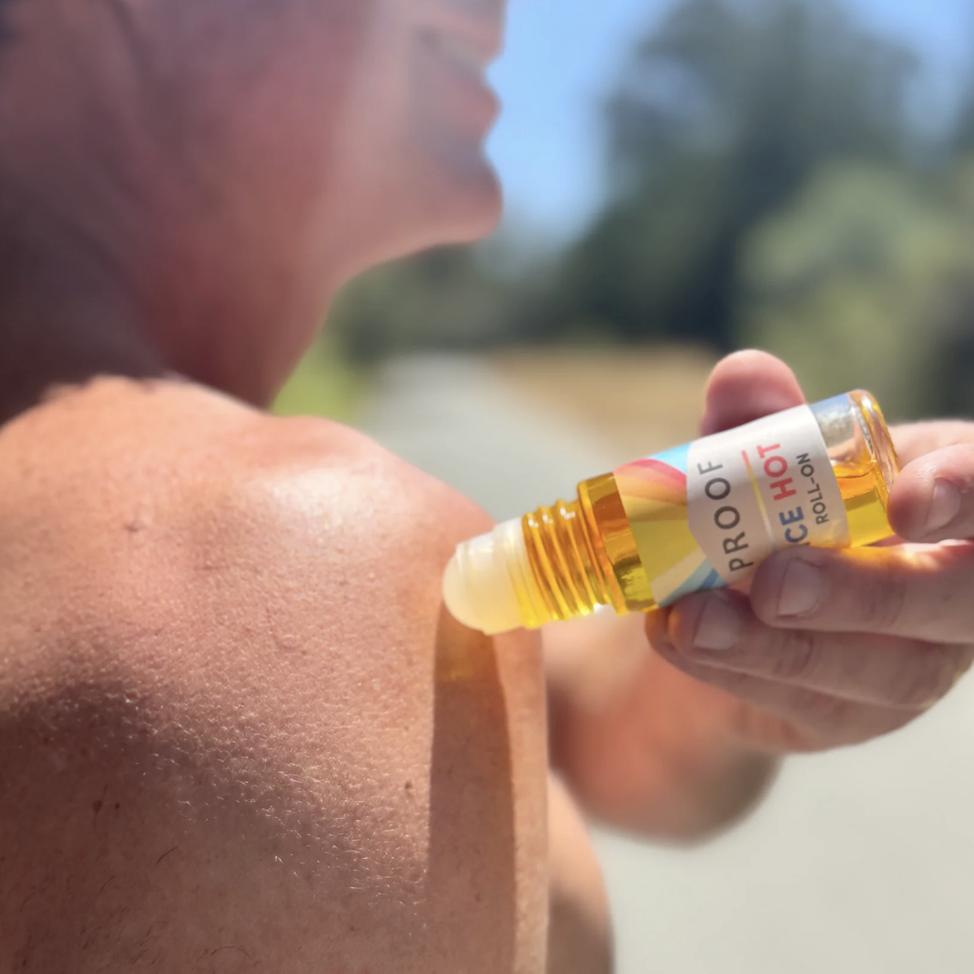 Man putting Proof Remedy CBD Ice Hot Roll-on his shoulder