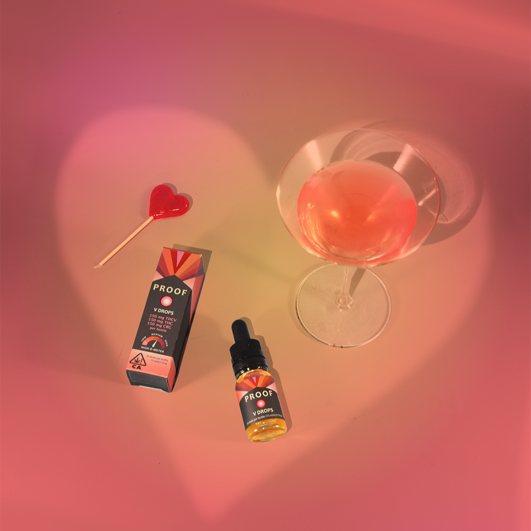Proof THCV Drops in heart shadow with a mixed drink