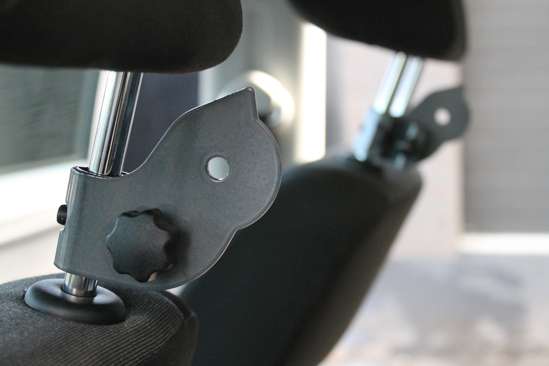 Clamps attach to the headrest pole