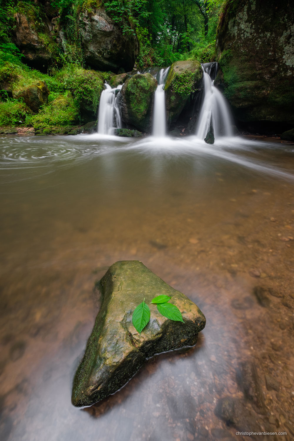 Visit the Mullerthal - Luxembourg - Luxembourg's Schiessentumpel waterfall in the Mullerthal region on a rainy summer day - The Lonely Rock