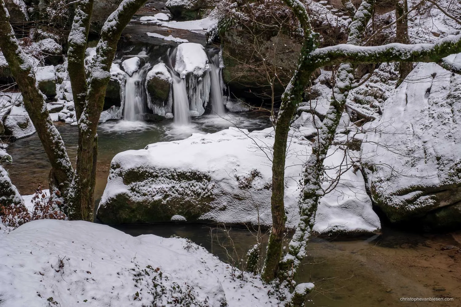 Visit the Mullerthal - Luxembourg - A cold winter has frozen parts of the Mullerthal's Schiessentumpel waterfall in northeastern Luxembourg - Winter's Grasp