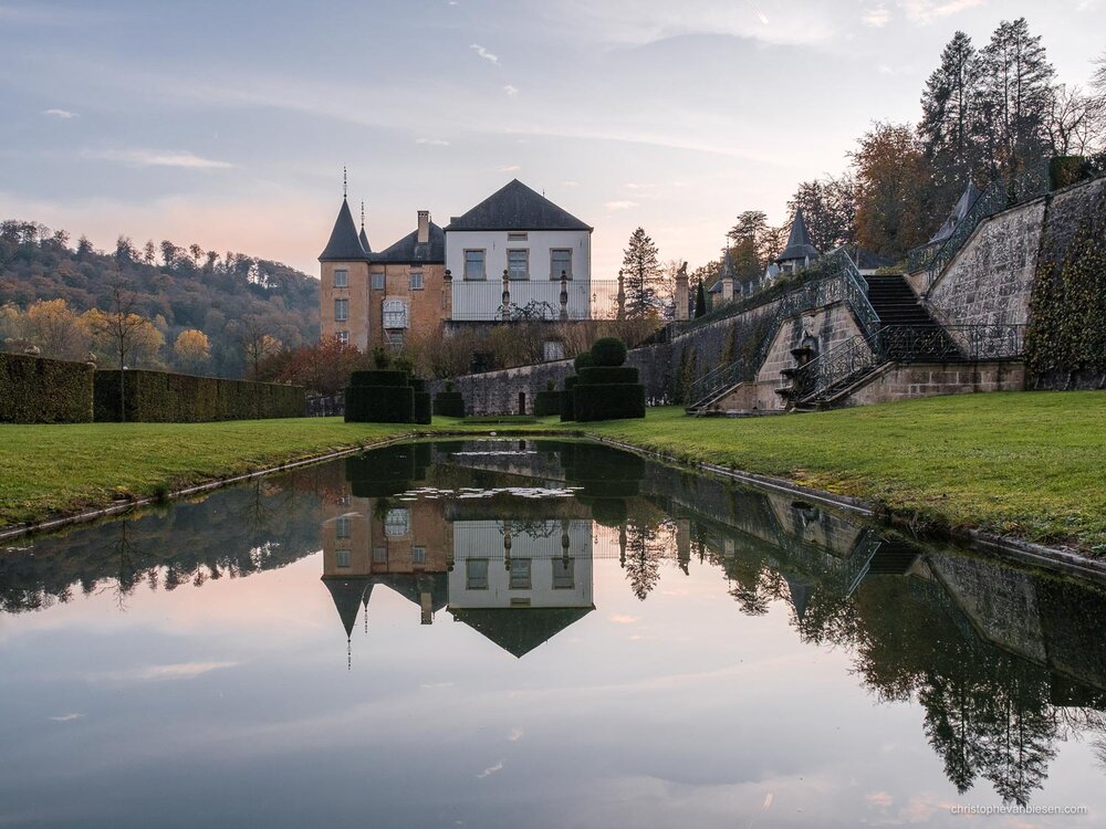 The New Ansembourg castle reflected in a nearby pond during autumn.