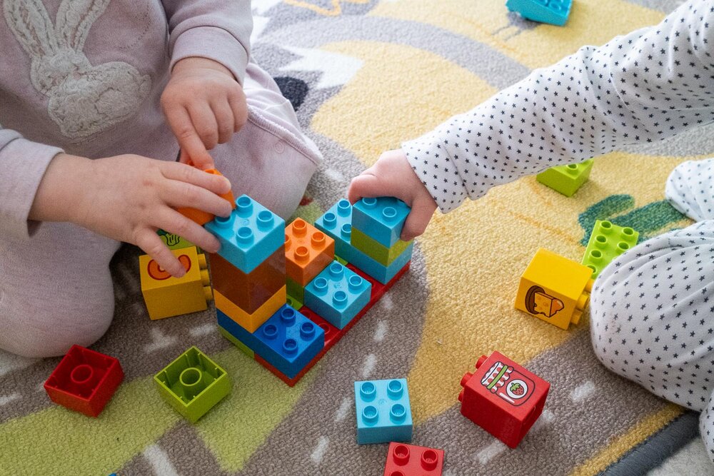 The twins enjoy playing with building blocks, even if it does not keep them busy for a long time!