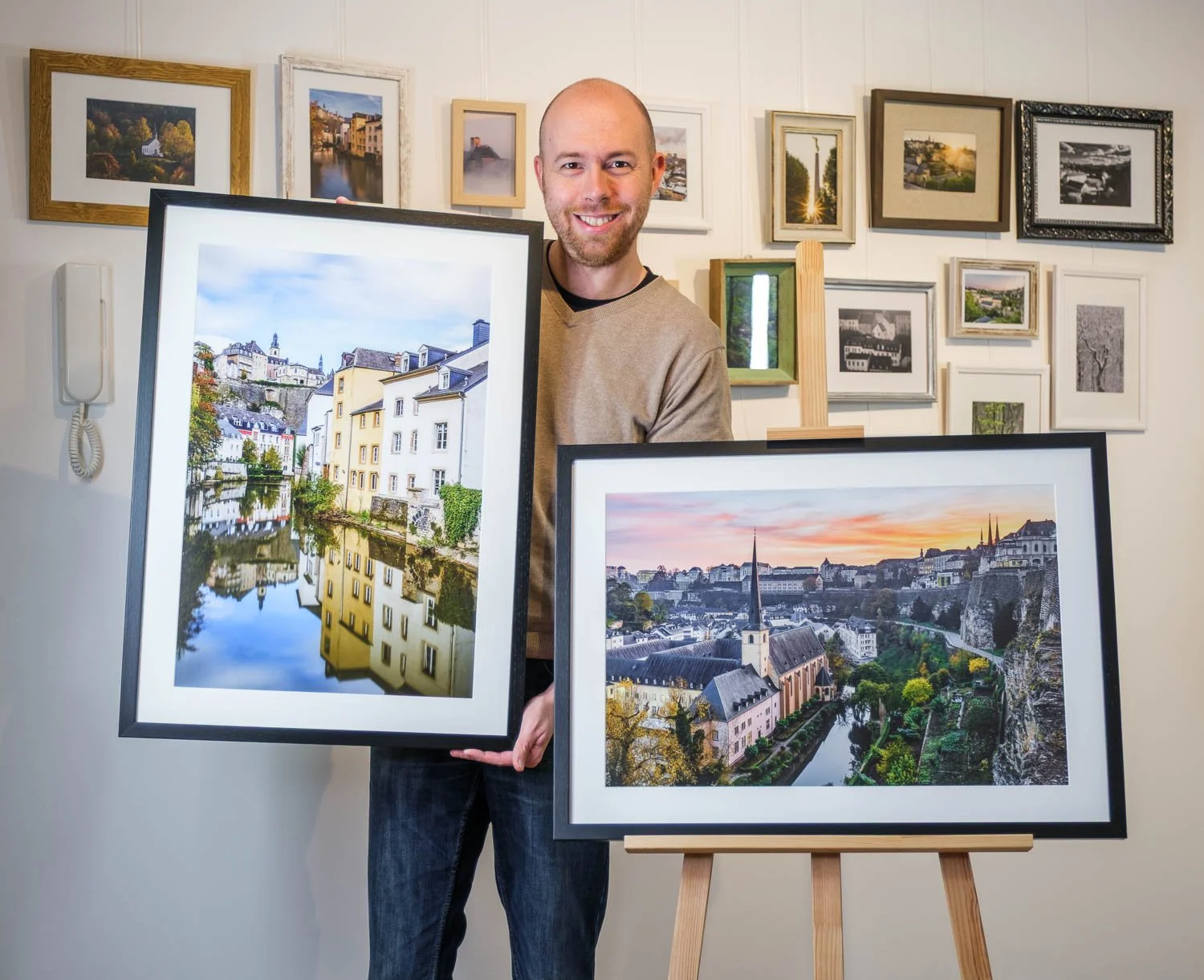 Christophe Van Biesen presenting framed fine art photographs of Luxembourg
