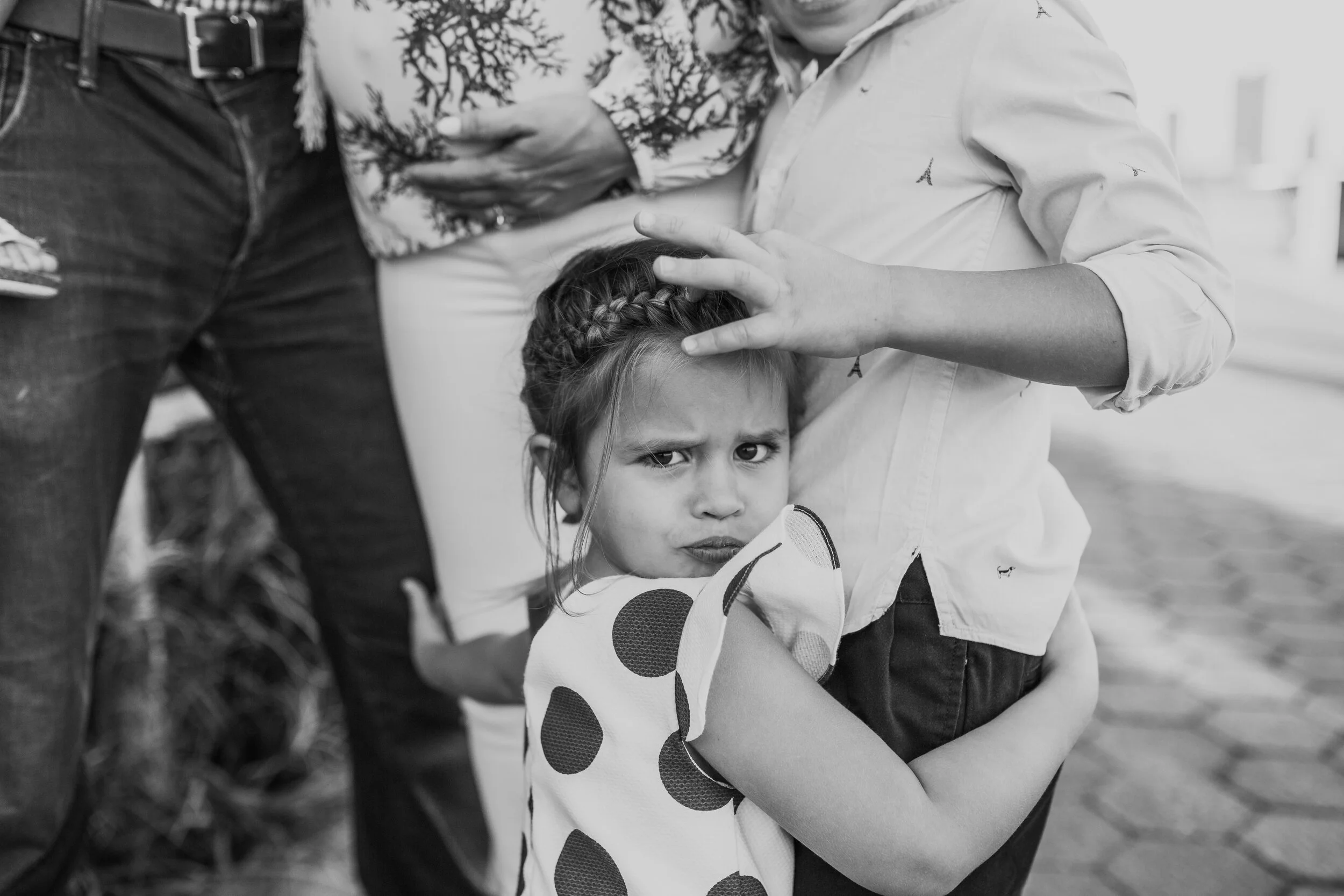 Little girl hugging her brother and pregnant mother during a maternity session in tribeca
