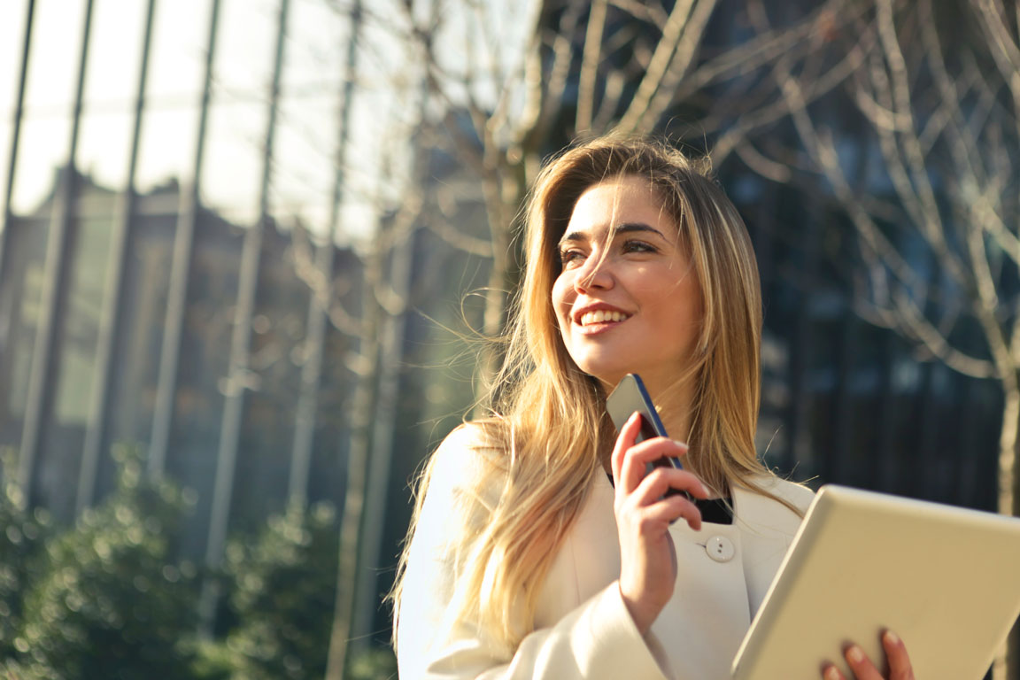 woman-outside-with-phone-and-notebook.jpg