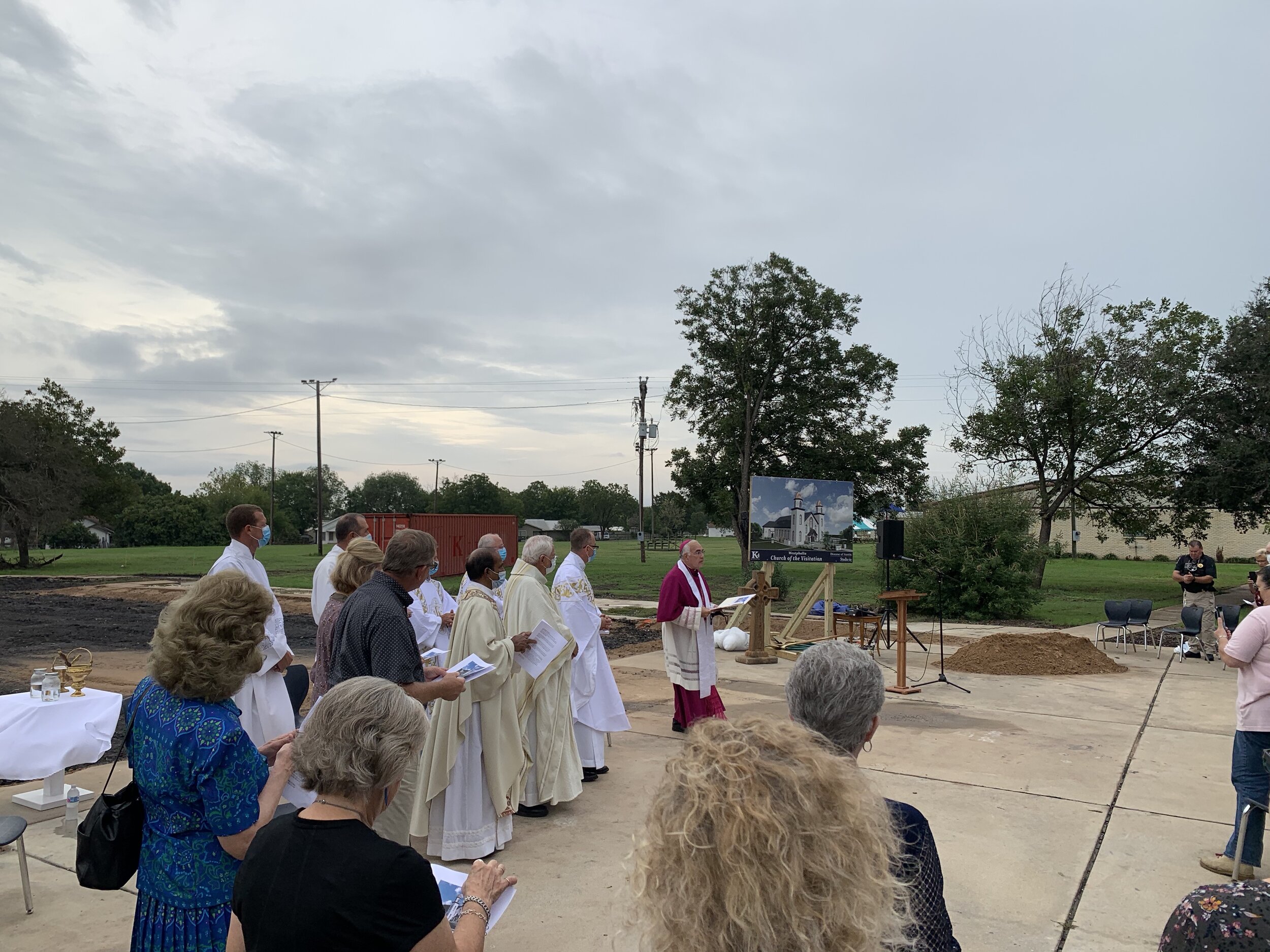  Bishop Vásquez leads the opening prayer for a community eager for signs of progress towards rebuilding their beloved spiritual home. 