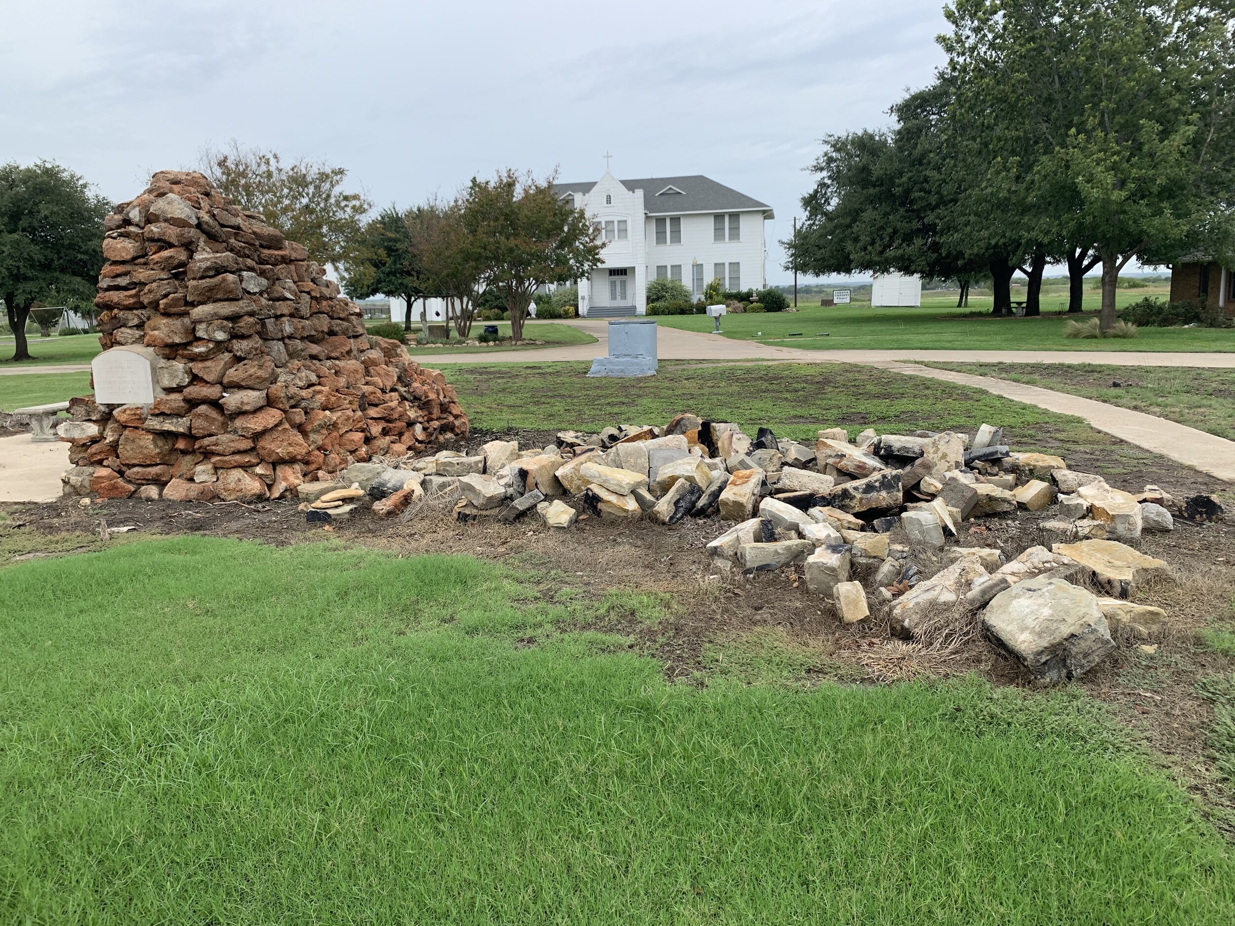  A pile of old stone footings also bear the ash and suit as evidence of the file that toppled the historic structure that stood on top of them for almost 125 years. 