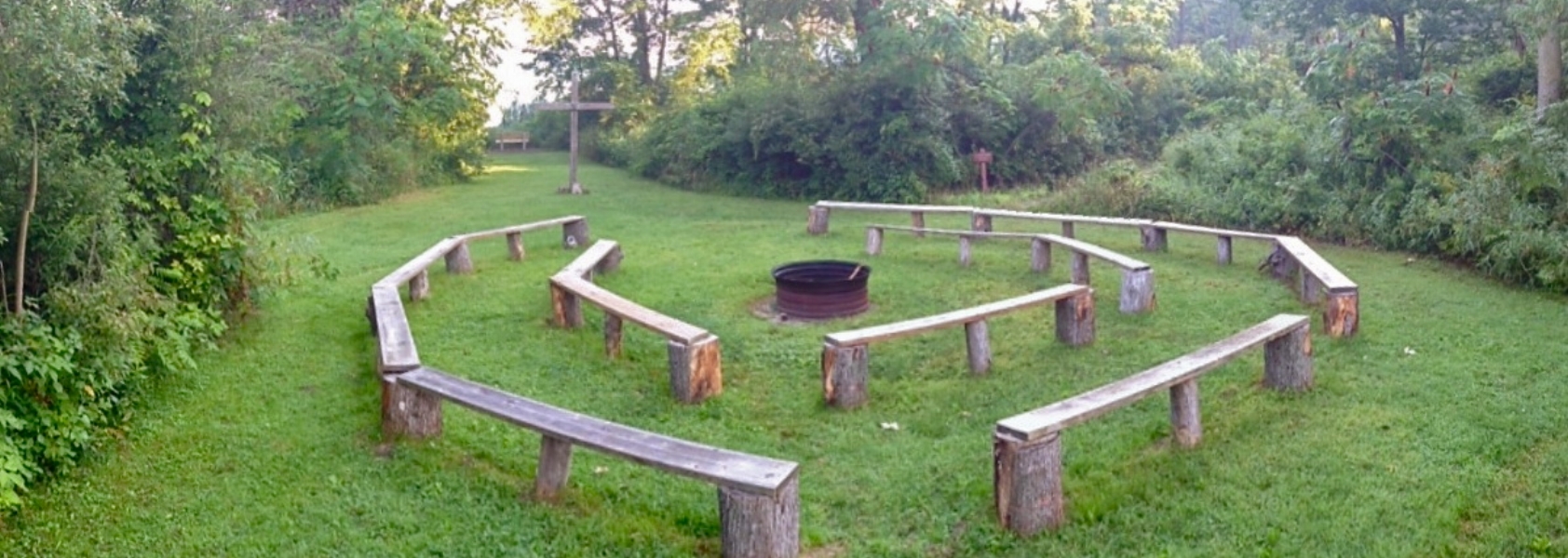  Our campfire area can seat about 75 people around a centrally located fire ring. It's very near Round Lake, so evening sunsets will be able to set the mood for your group here. We have also recently updated our benches. 