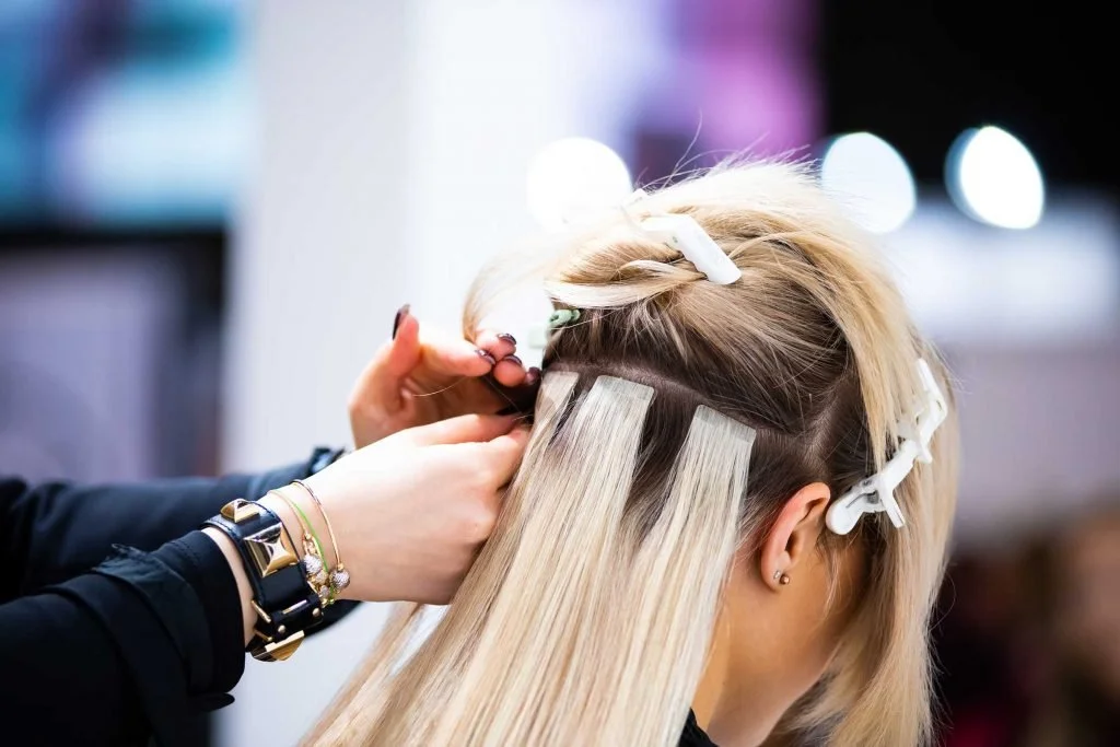 professional hairdresser making hair extensions.jpg