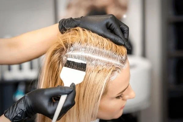 Hair root touch-up application at salon in Sunny Isles Beach