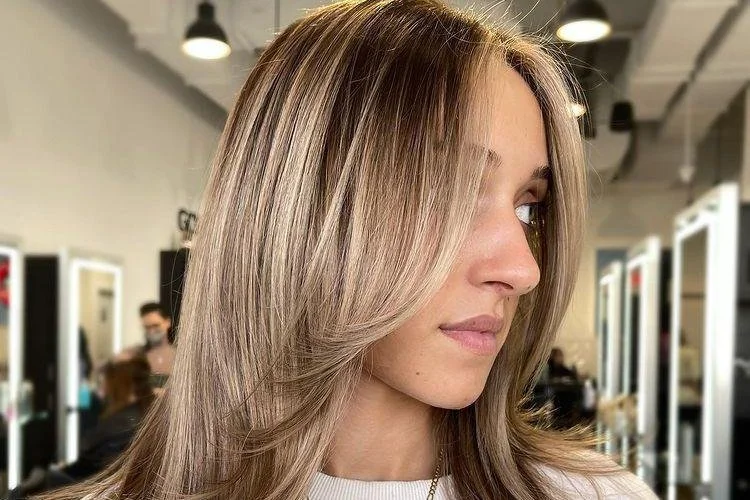 Face framing highlights around the face for natural brightness at salon in Sunny Isles Beach