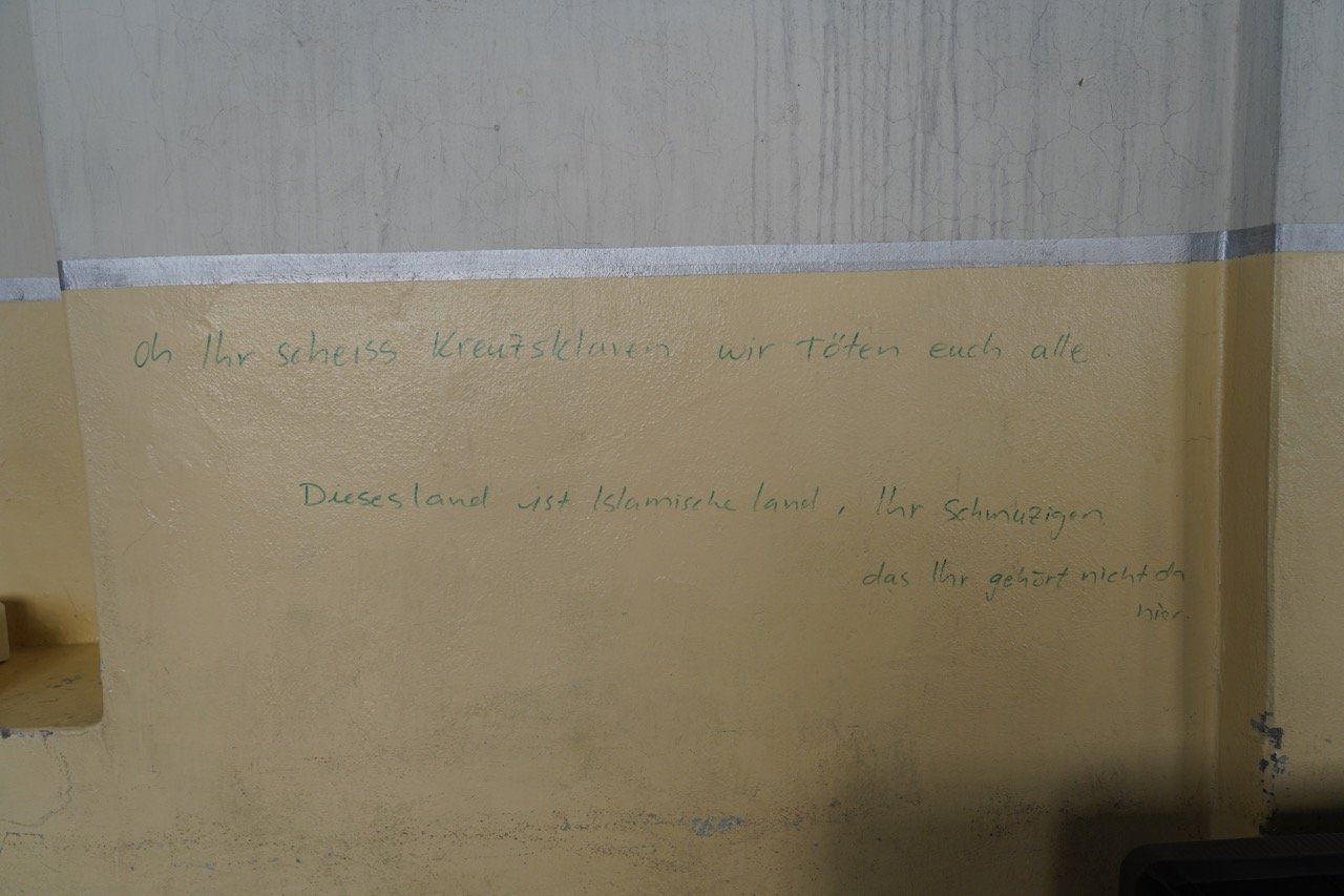 german words slur on wall church Large.jpeg