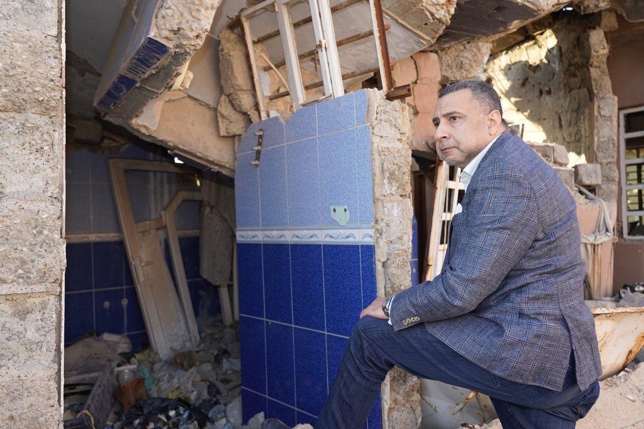 majed looking at destroyed building batnaya Large.jpeg