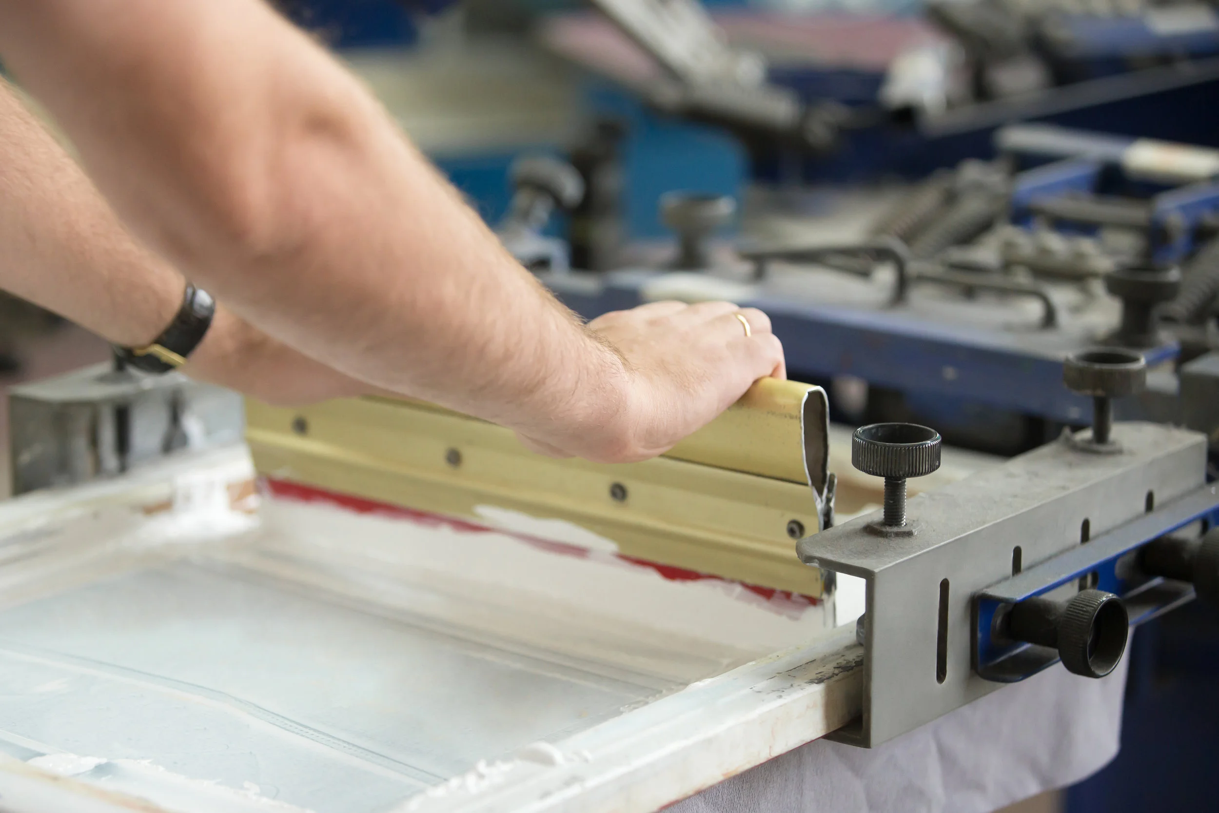 Squeegee and ink on silkscreen press