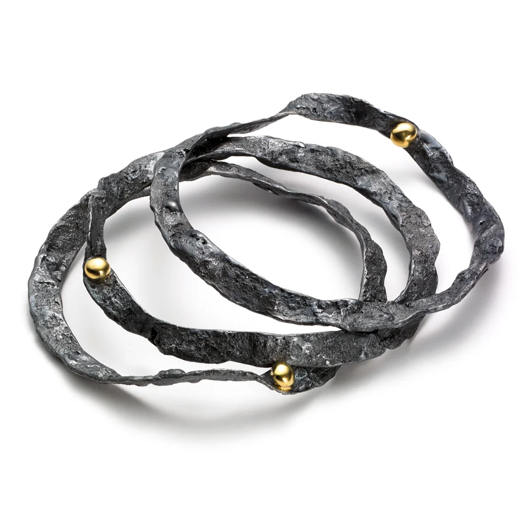 ED95B Burst bangles. Blackened sterling silver, 18k yellow gold.