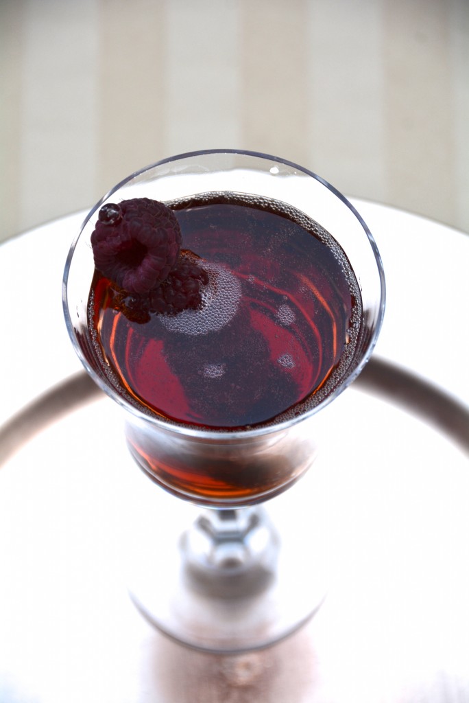 Pimms cocktail with bubbly and raspberries