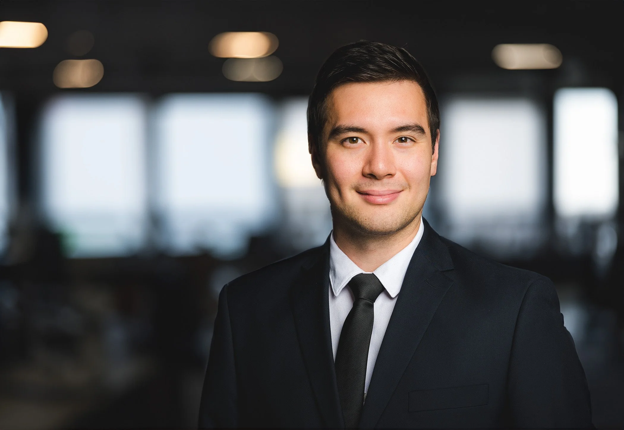 On-location team headshot of a smiling professional in their office in Northern Virginia, part of a corporate team headshot session by Gabriele Stonyte Photography
