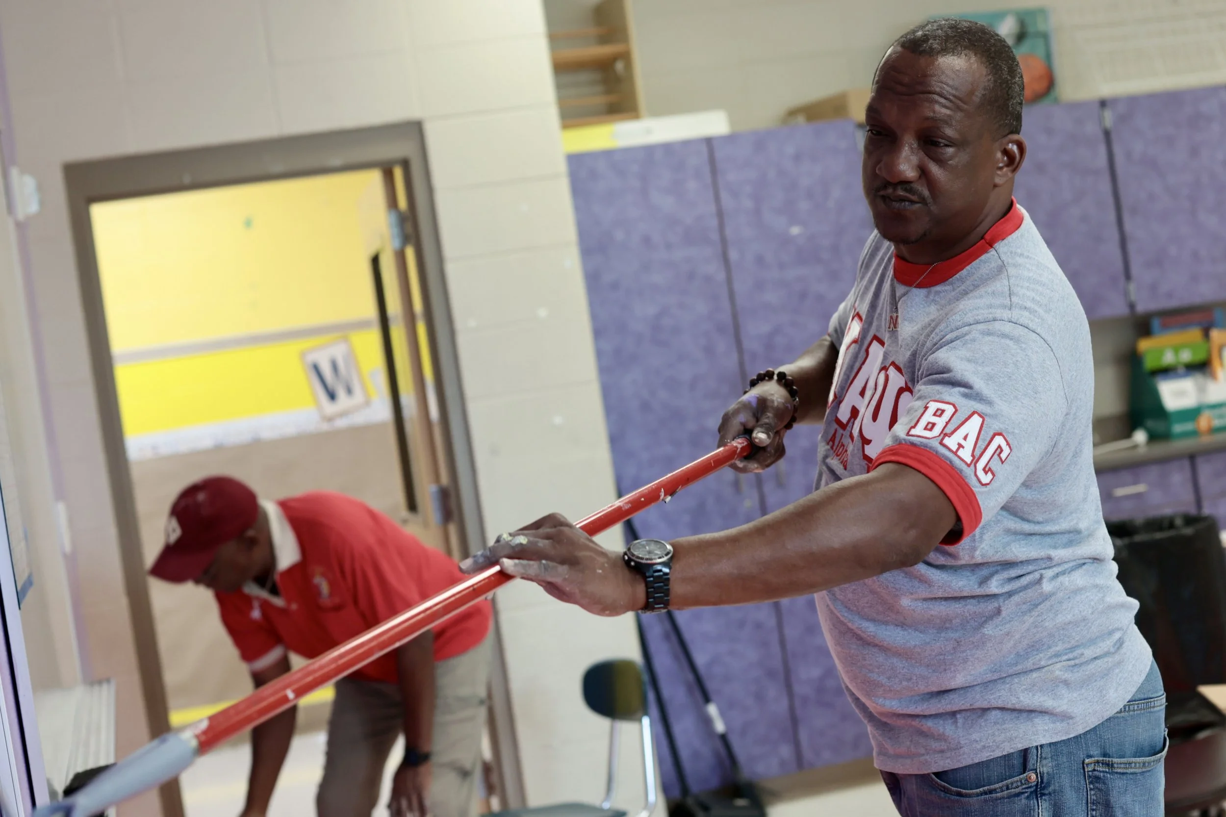 Brother Julius Howard painting during Booker T. Washington Middle school community clean up.