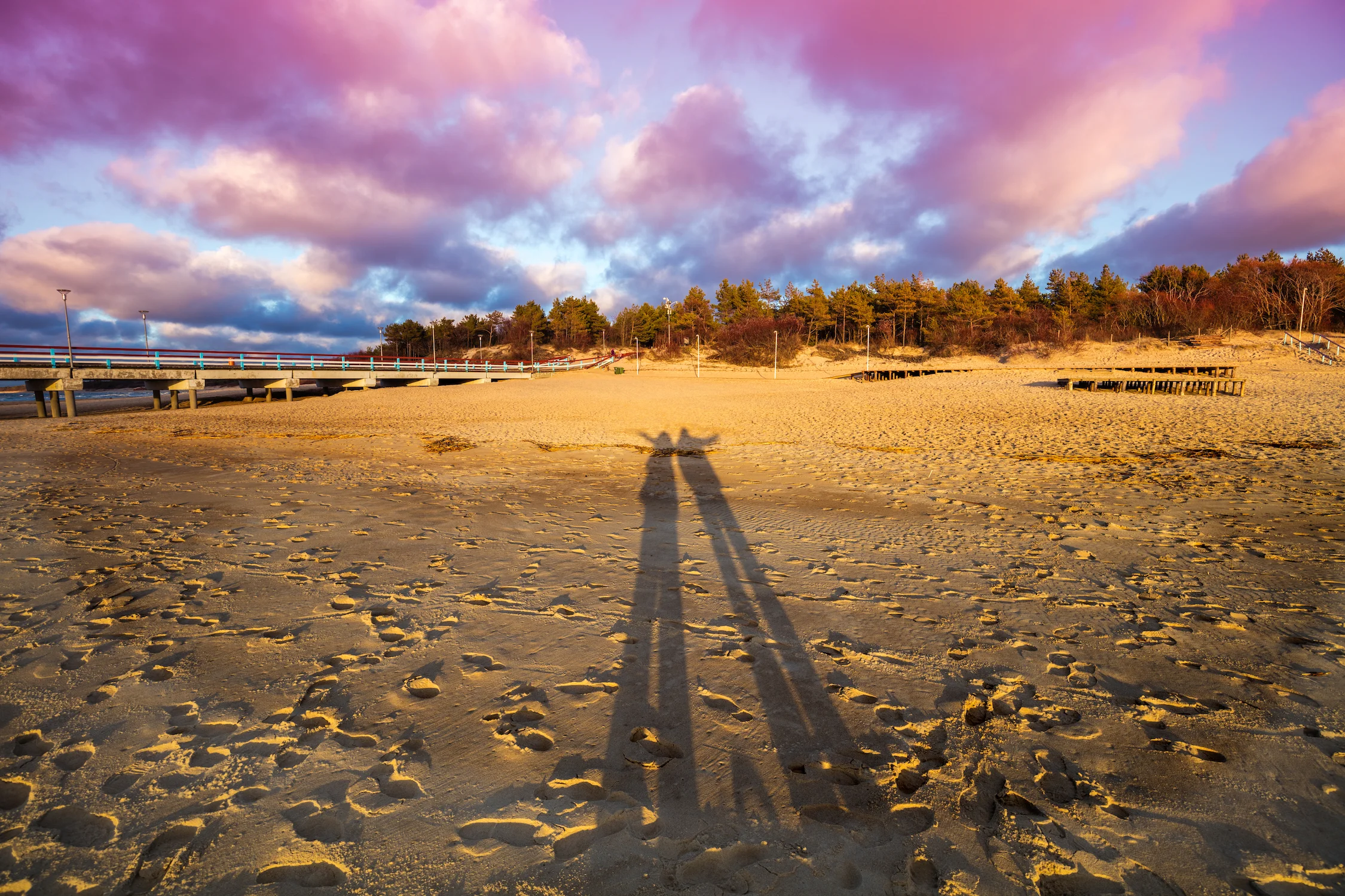storyblocks-long-shadows-of-man-and-woman-on-the-beach-at-sunset_SRdNOWYyz.jpg