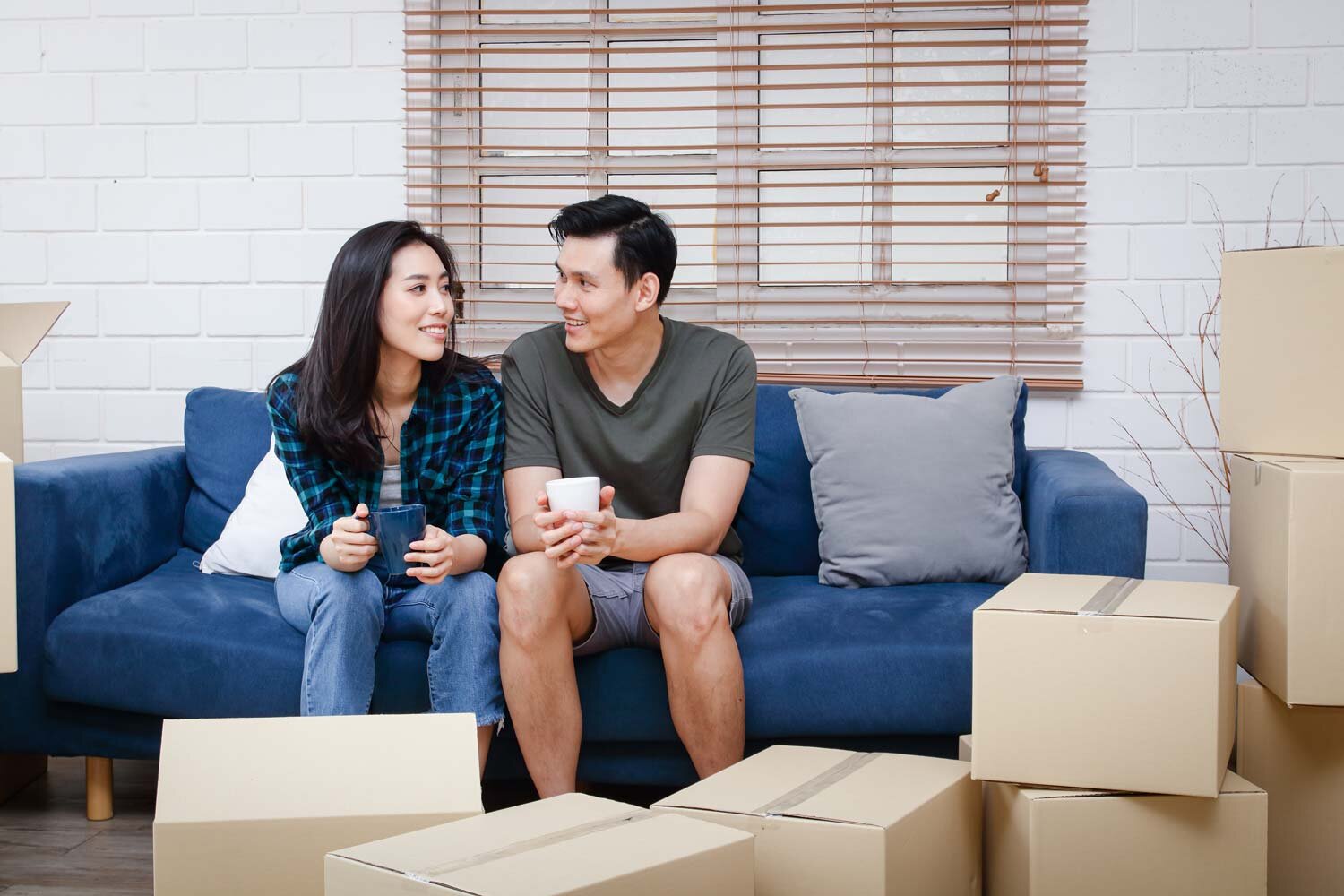 asian-couple-sits-sofa-just-moved-into-new-home-create-warm-family.jpg
