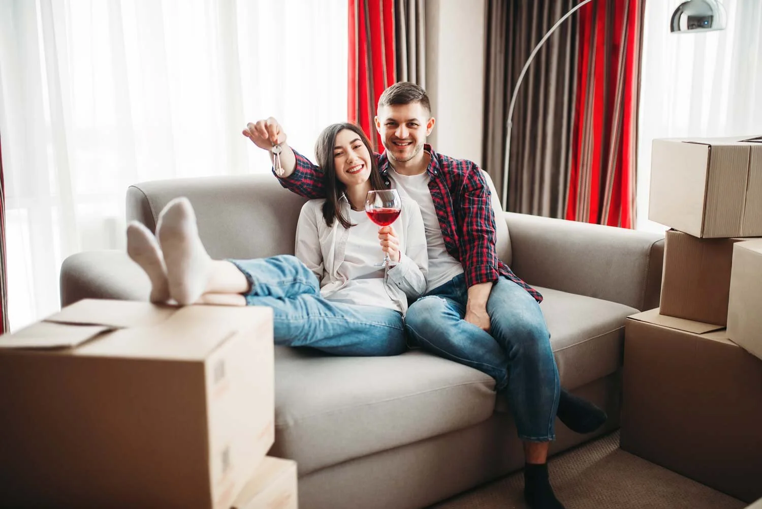 happy-couple-drinks-red-wine-celebrate-moving-new-house-relocation-apartment-celebration.jpg