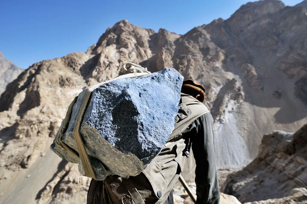 Lapis lazuli stone being carried by a miner in Afghanistan.