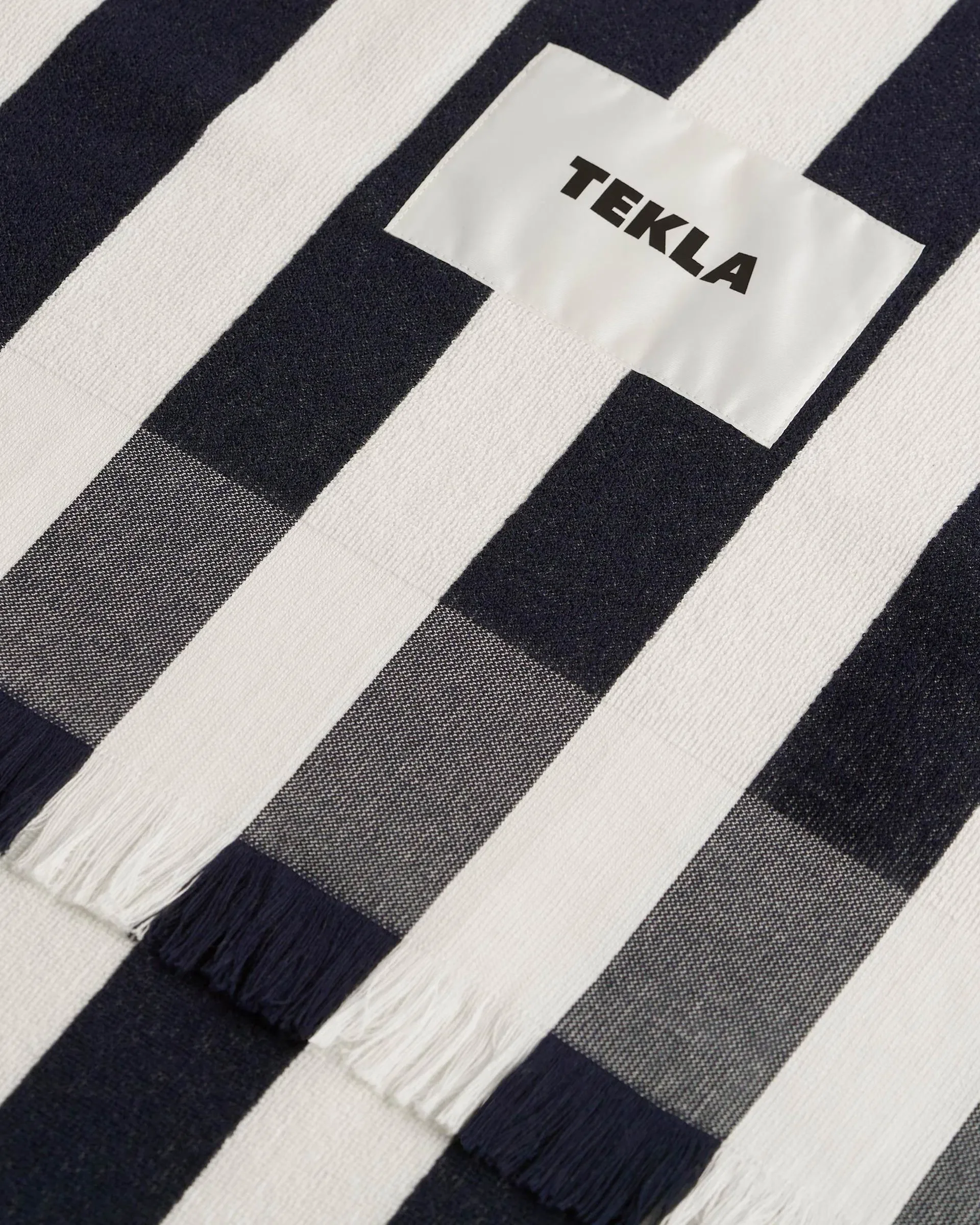 tekla-beach-towels-for-him-product-close-up-black-and-white-stripeshttps-:teklafabrics.com:product:beach-towel-cala-stripe.webp