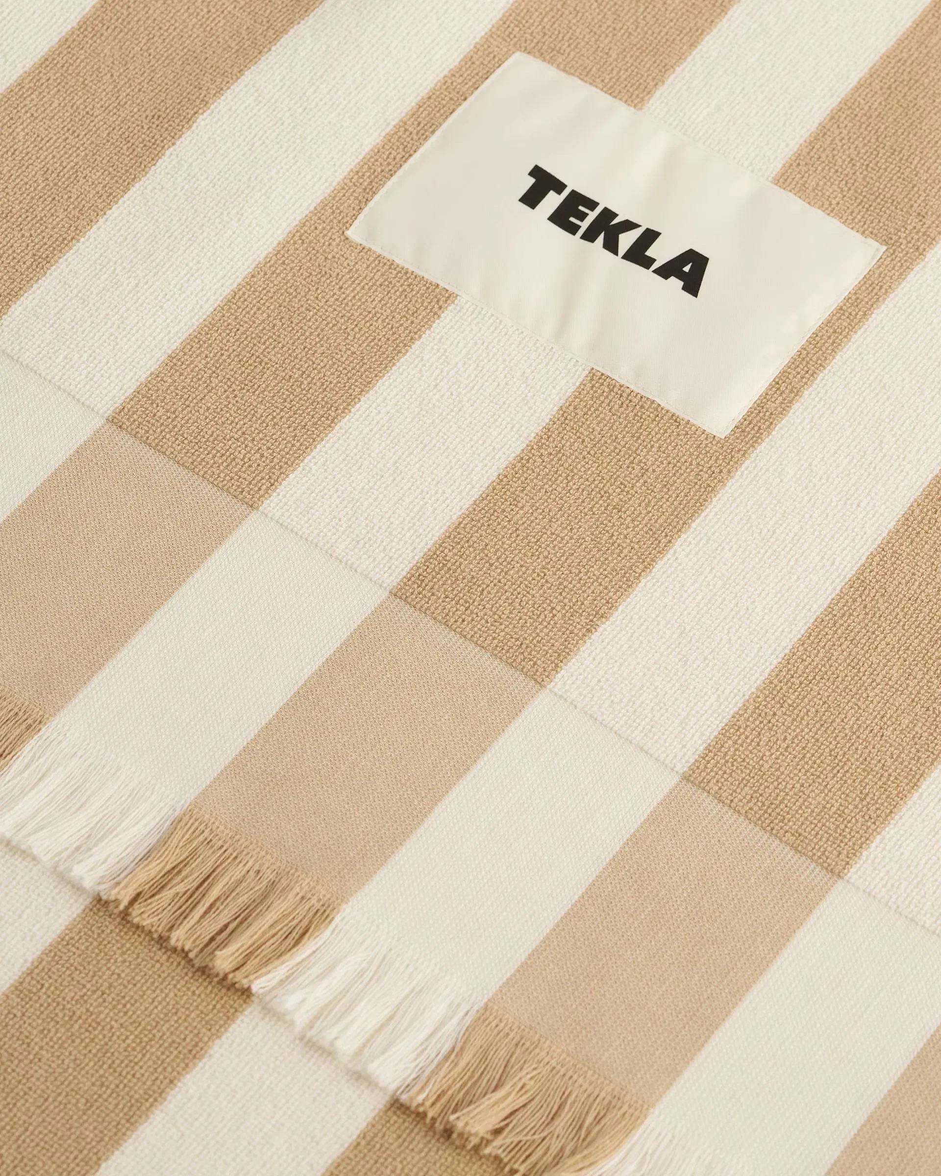 tekla-beach-towels-for-him-product-close-up-black-and-white-stripeshttps-:teklafabrics.com:product:beach-towel-white-stripe.webp