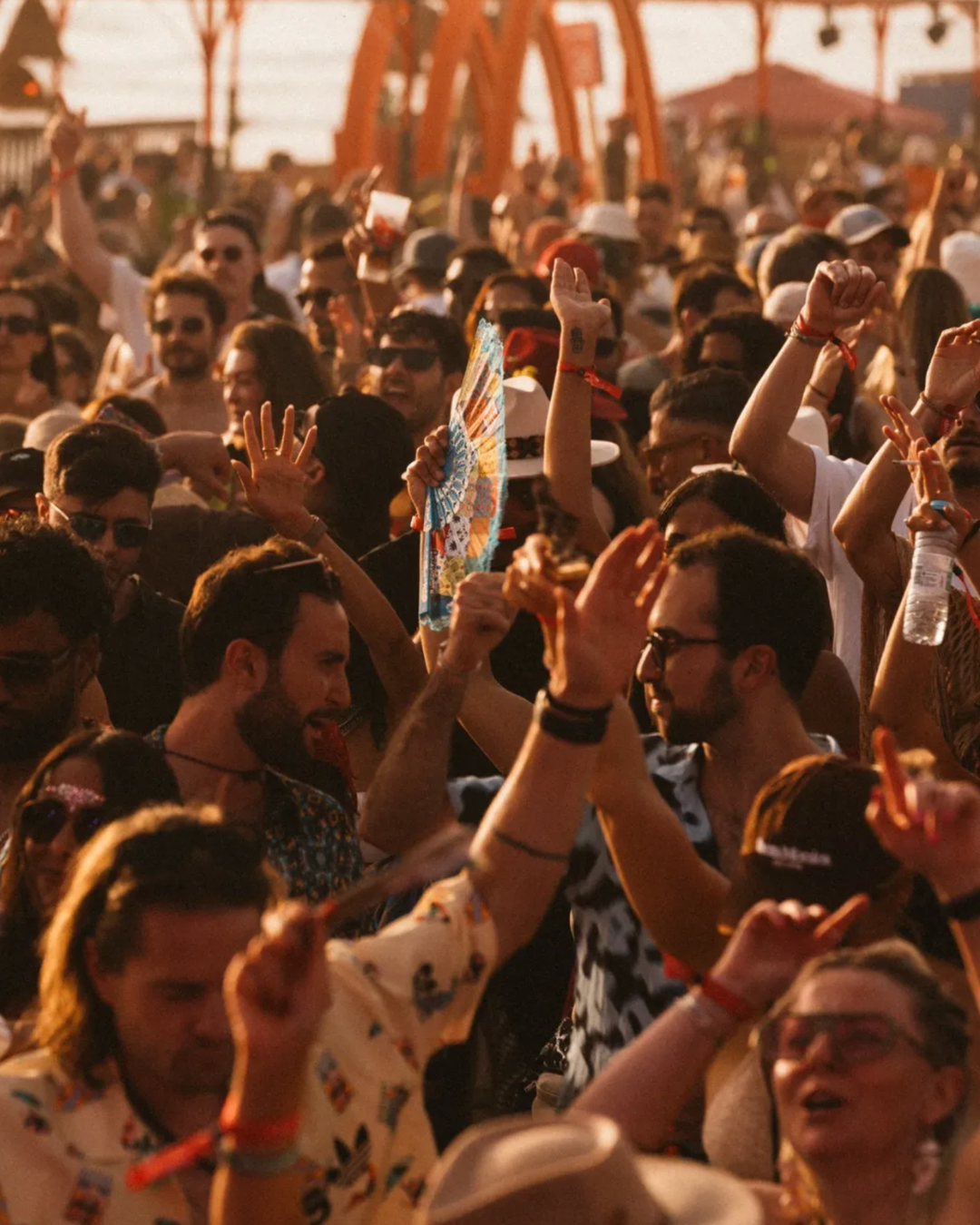Festival crowd dancing in golden hour light at MOGA Festival, Costa da Caparica