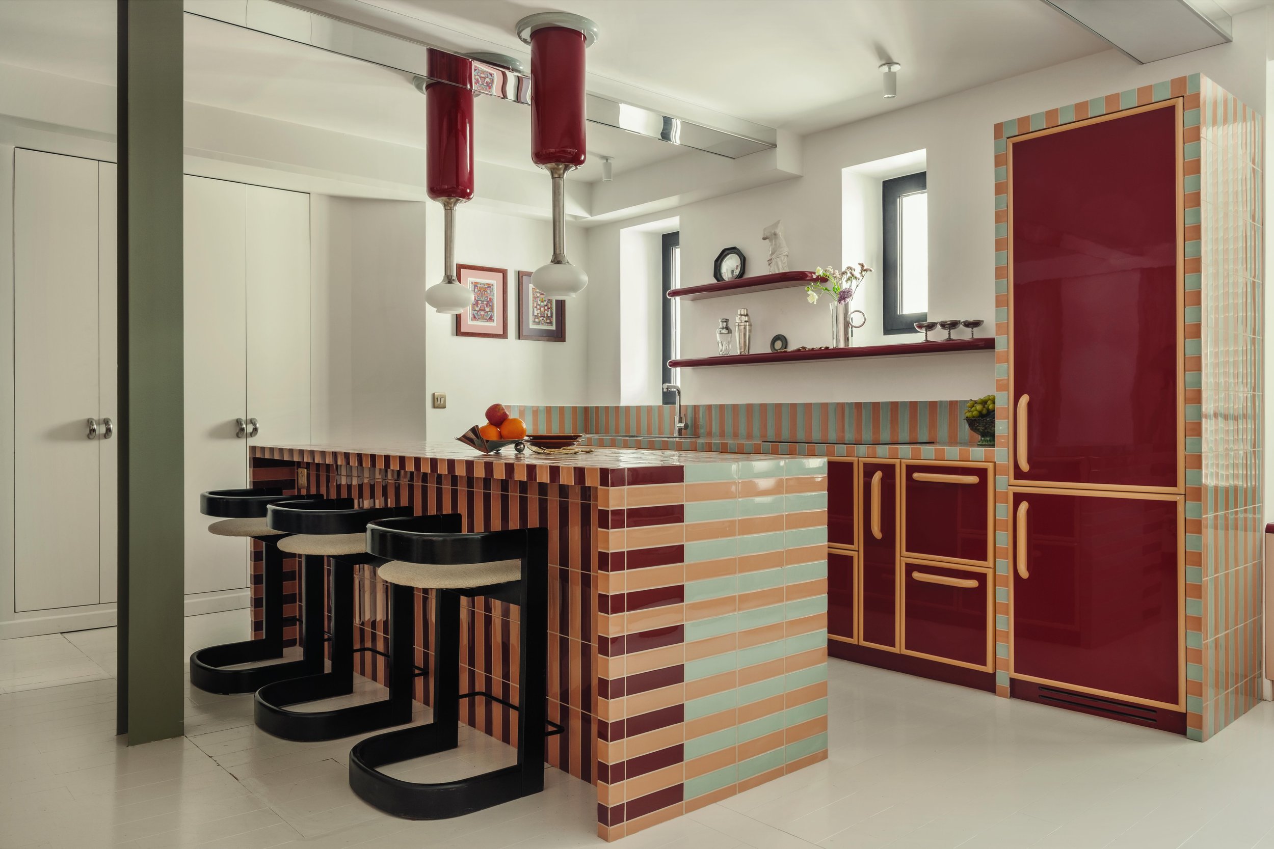 Pigalle apartment kitchen Paris with colourful tiled countertop and lacquered surfaces